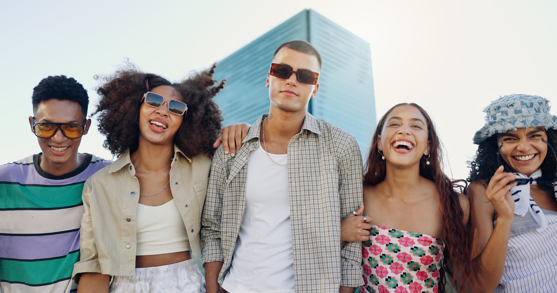 Urban, happy and friends in city with fashion in summer for cool, edgy or trendy style together. Diversity, gen z men and group of creative women in town for street culture, unique clothes or swag