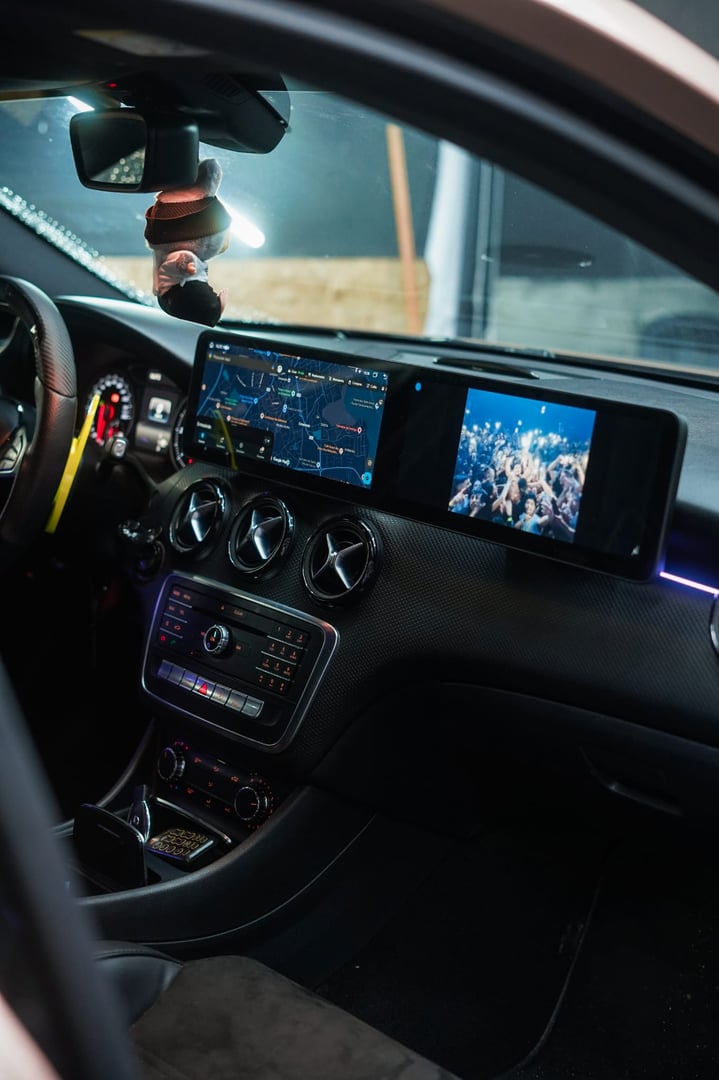 Woman driving car using navigation system on dashboard to find right direction, close-up on hand