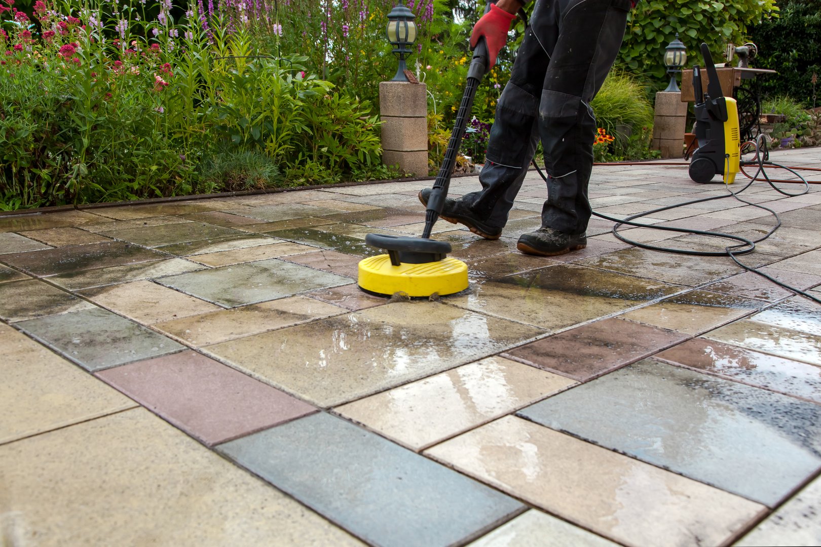 Person worker cleaning the outdoors floor.
