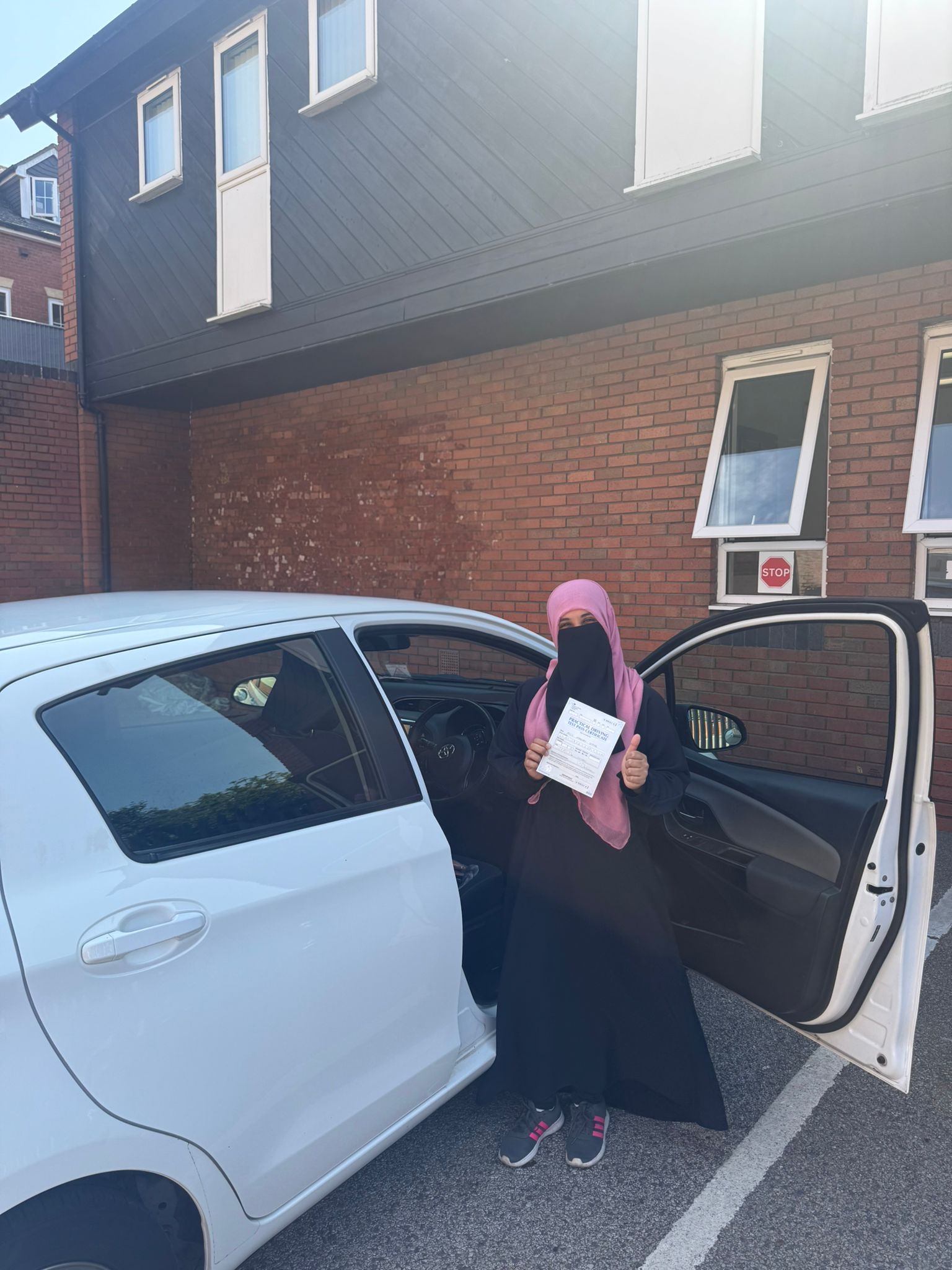 Successful driving test student Maryam with pass certificate