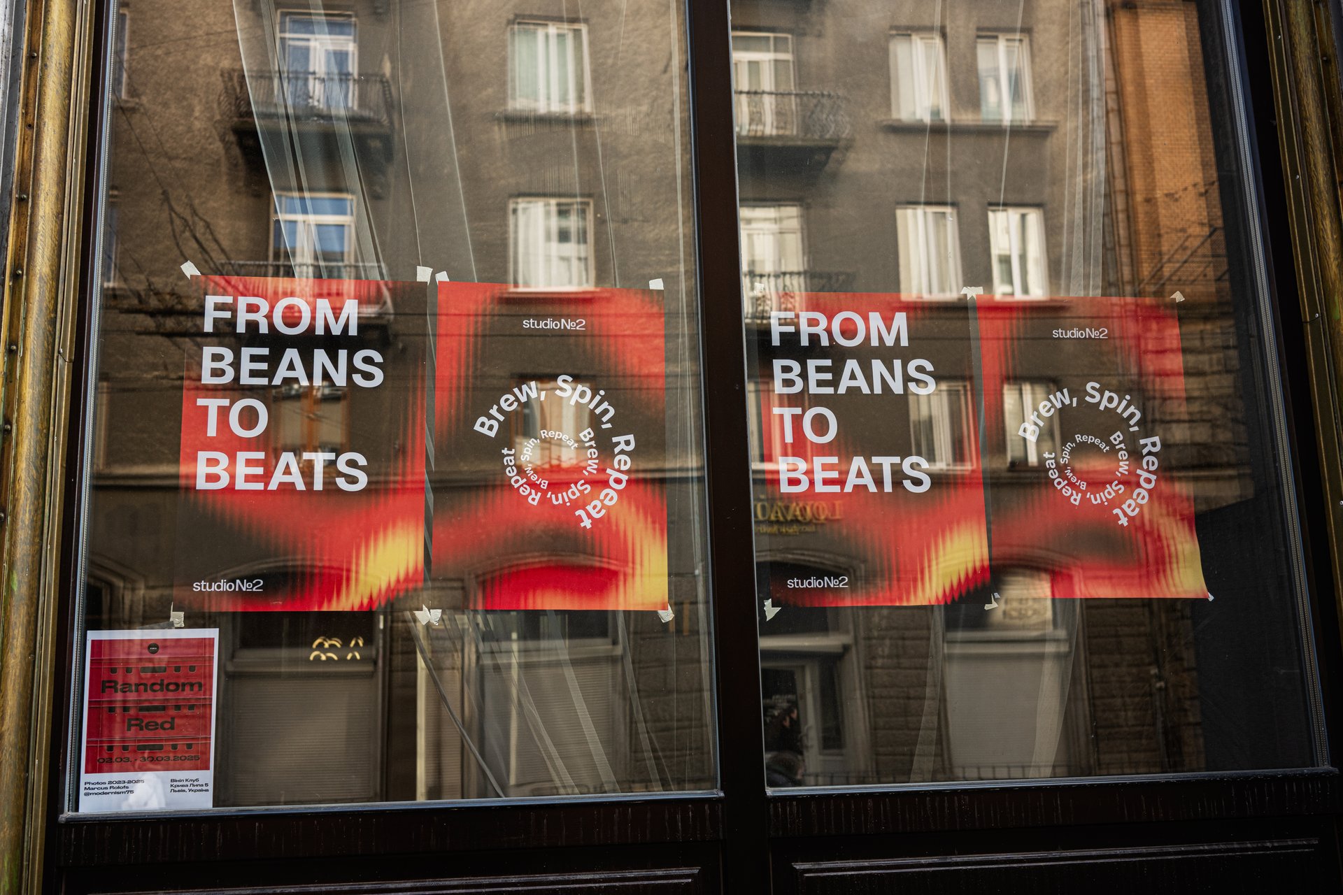 Lviv, Ukraine - April 01, 2025: Posters with the message 'from beans to beats' displayed on a glass facade.