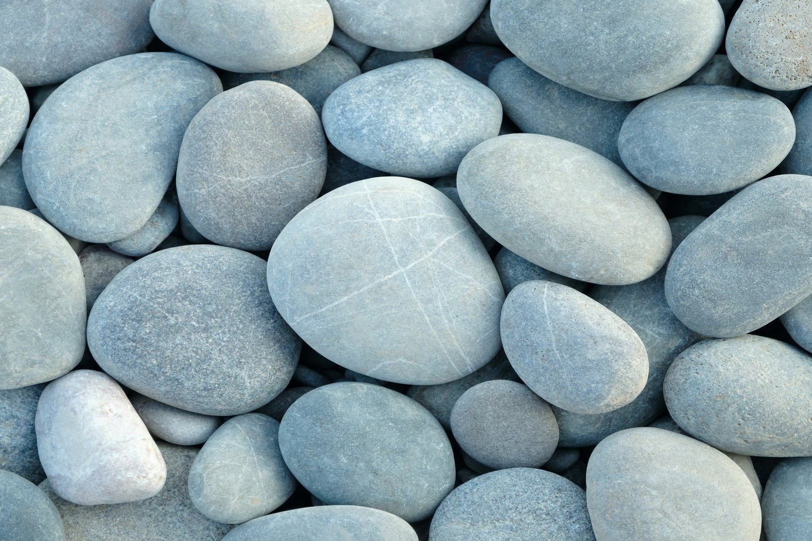 Pebbles stones on seashore as texture background
