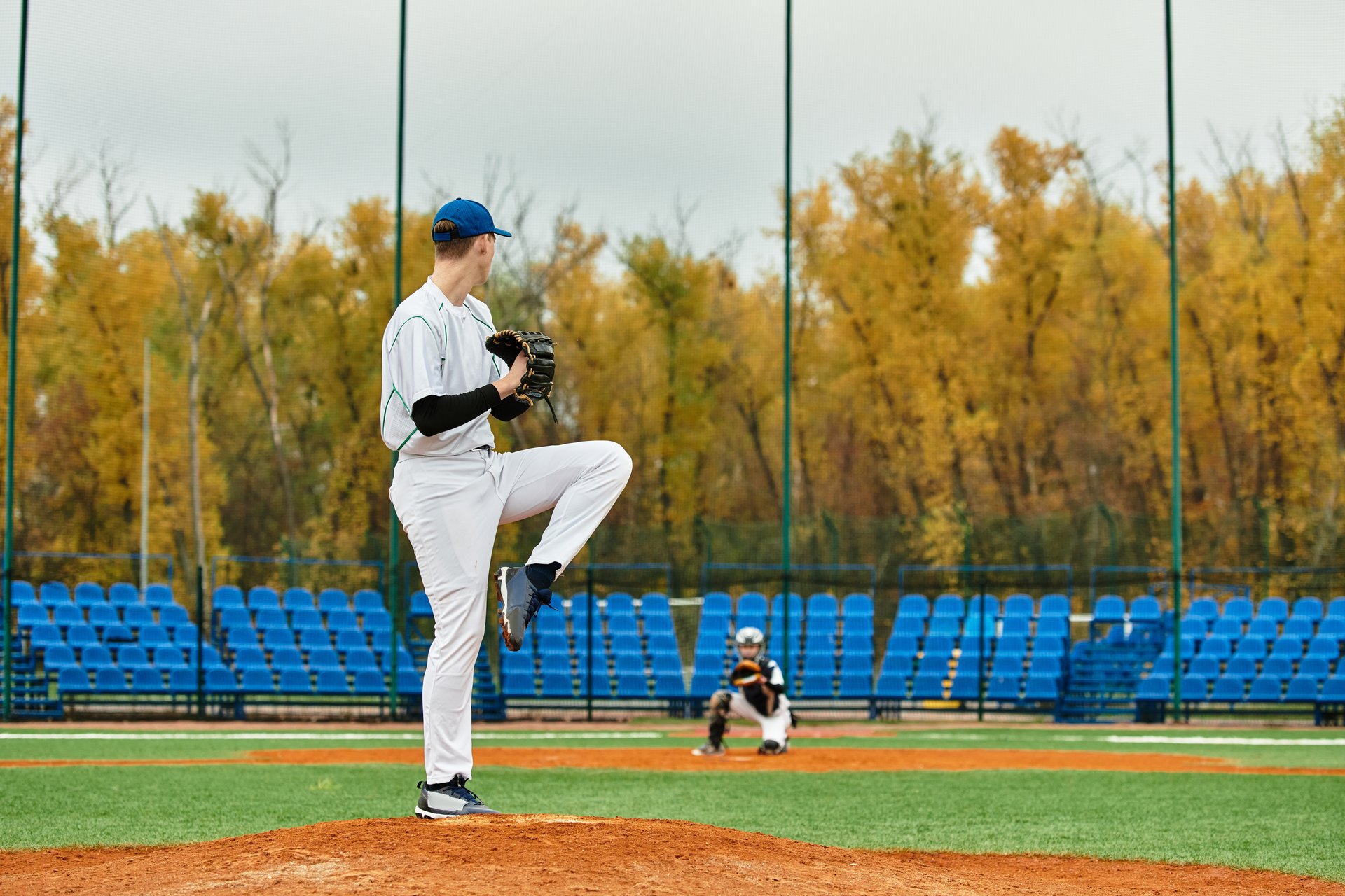 Teenage boys play an exciting game of baseball, showcasing their athletic skills.