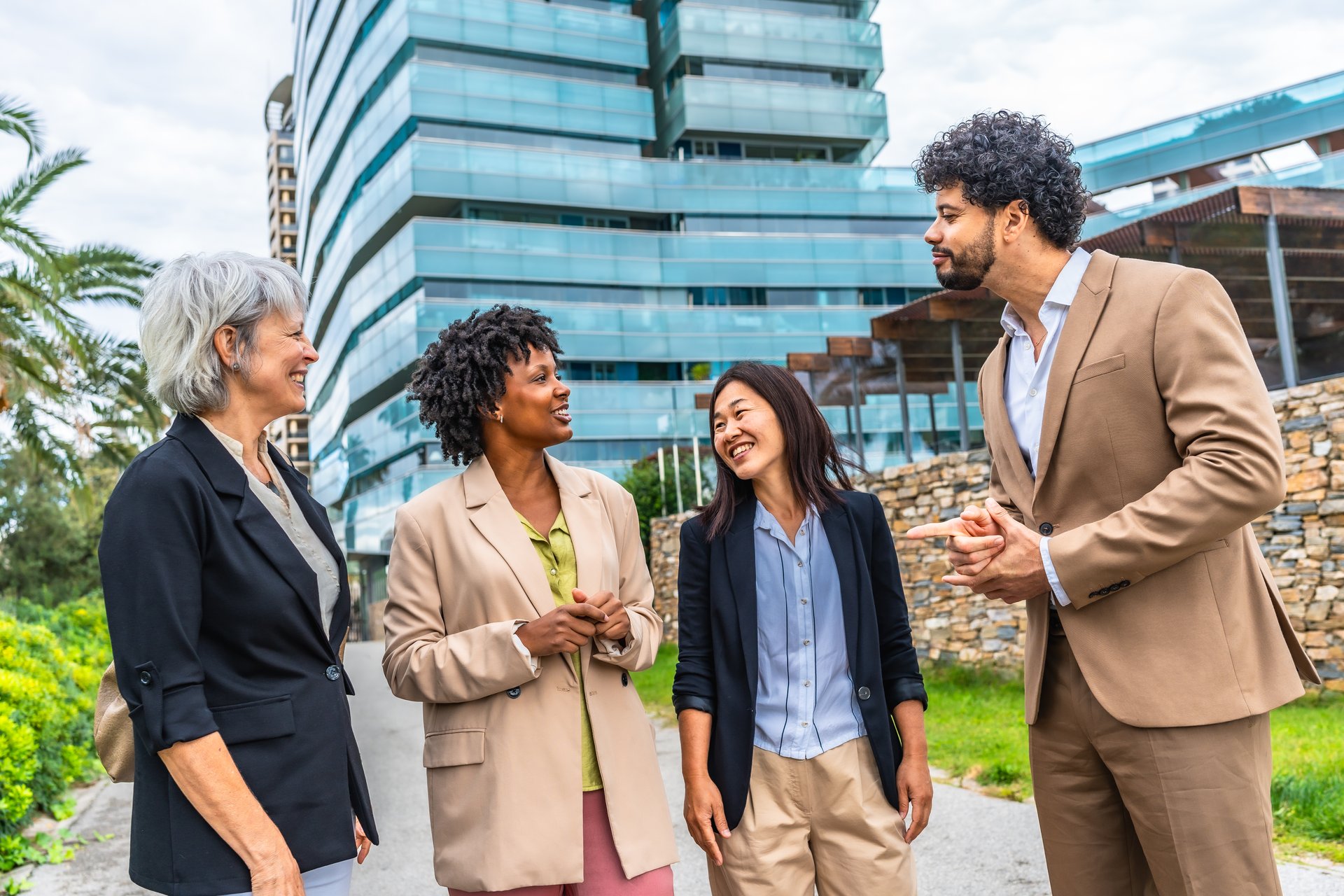 Diverse business team members talking standing in the city next to financial building