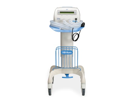 Medical respiratory machine with a control panel, tubing, and a wheeled stand for mobility and convenience.
