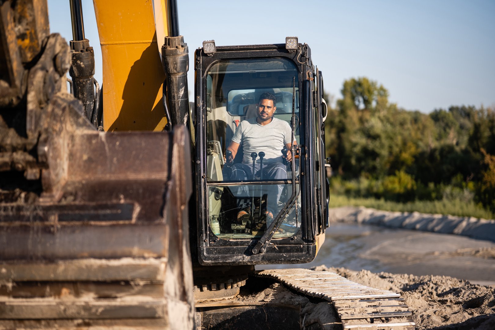 Construction worker operating excavator