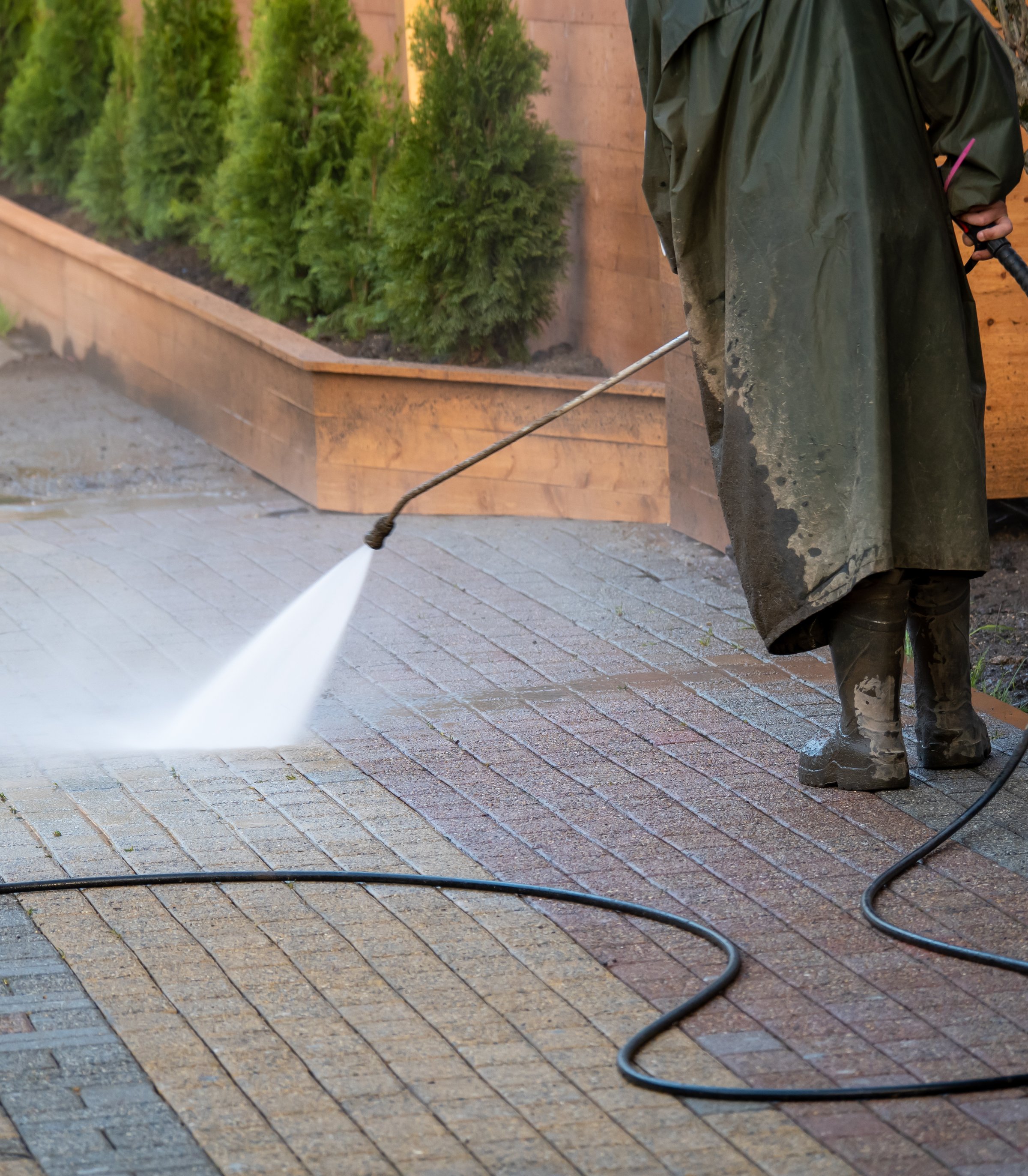 Man cleans a paved area