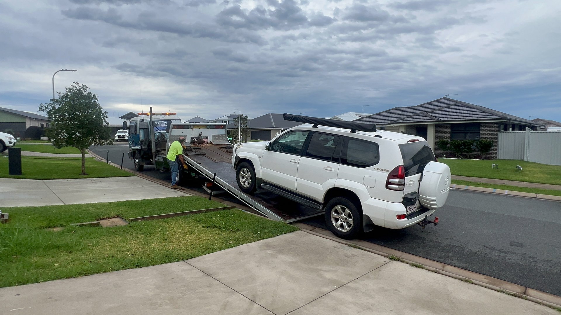 Port Macquarie, Nsw - May 27 2025:Truck driver of breakdown support and towing service truck towing a Toyota Land Cruiser Prado vehicle. Every year about 1.2 million cars broken down in Australia.