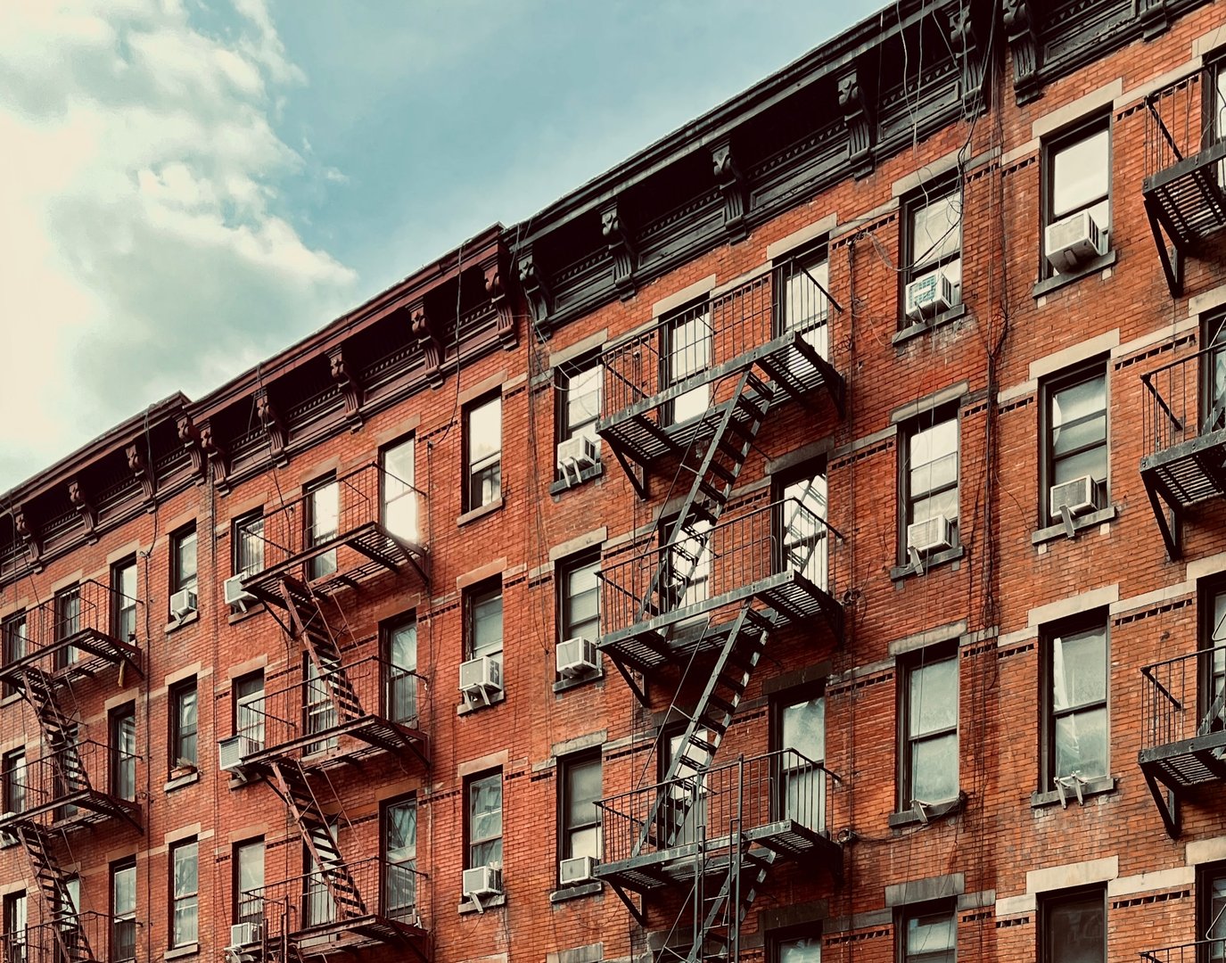 Historic brick apartment building with iconic fire escapes showcasing Boston's architectural charm
