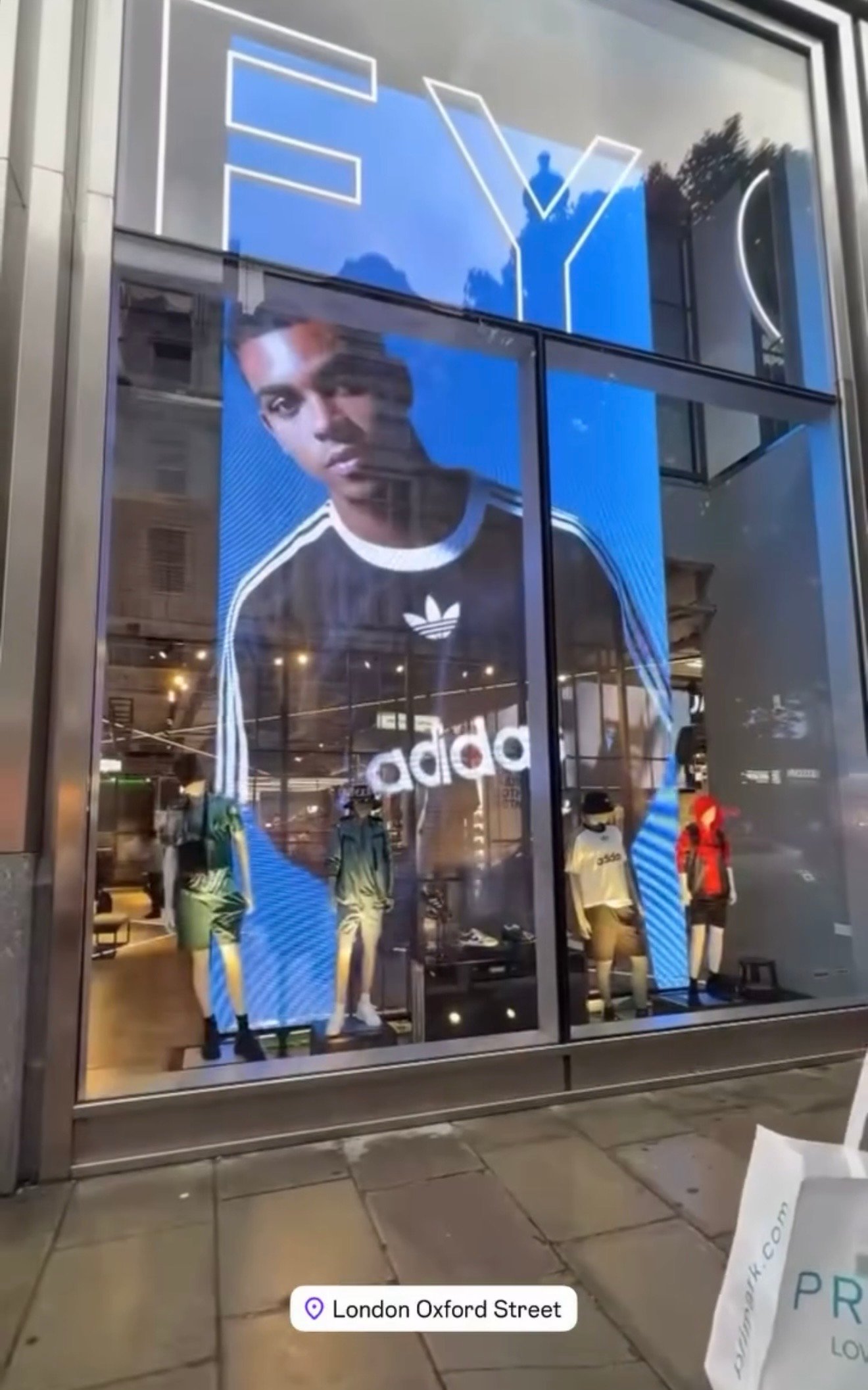 Male model showcasing Adidas t-shirt in global lifestyle fashion campaign