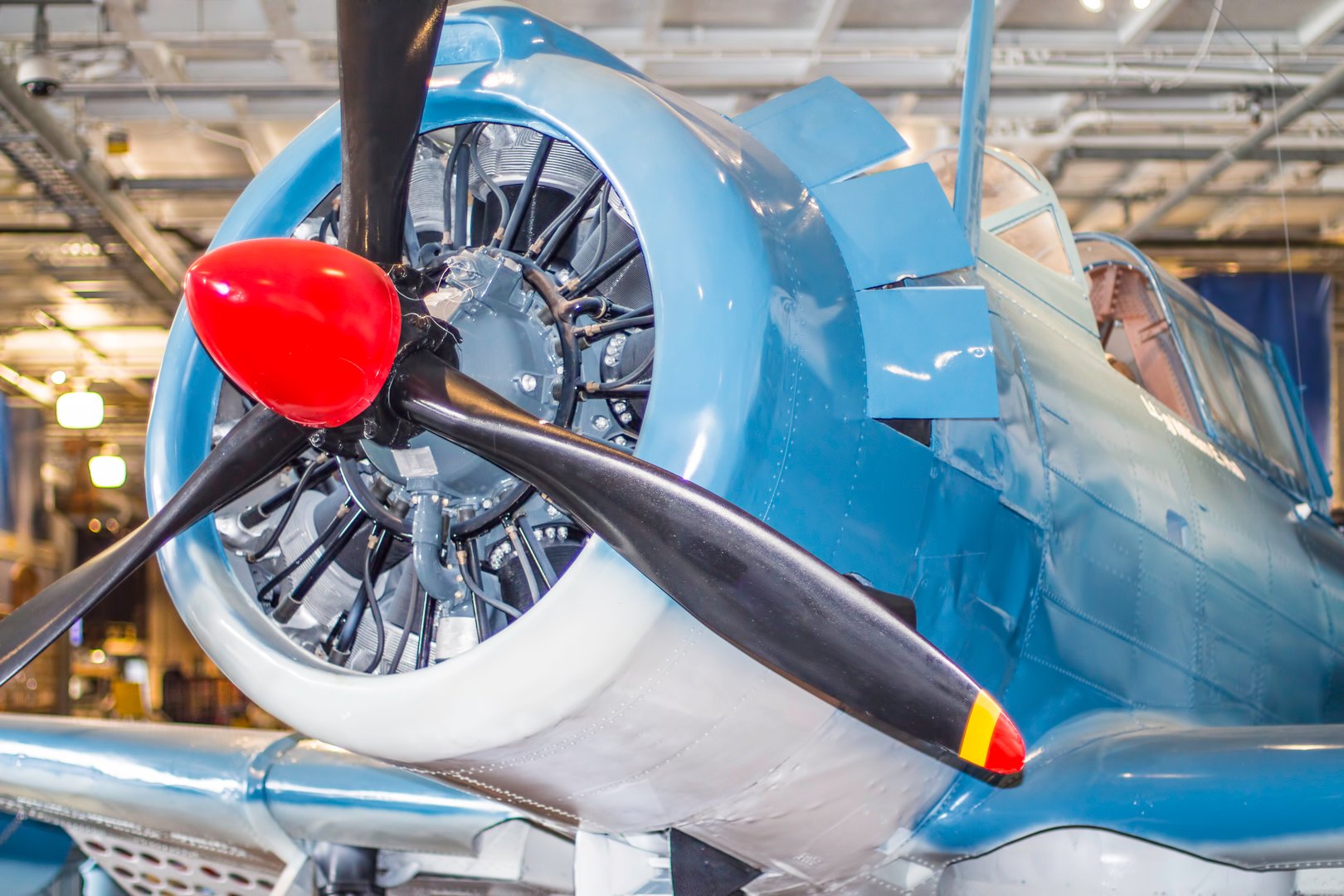 A front view of an old World War II airplane showing the engine and propeller