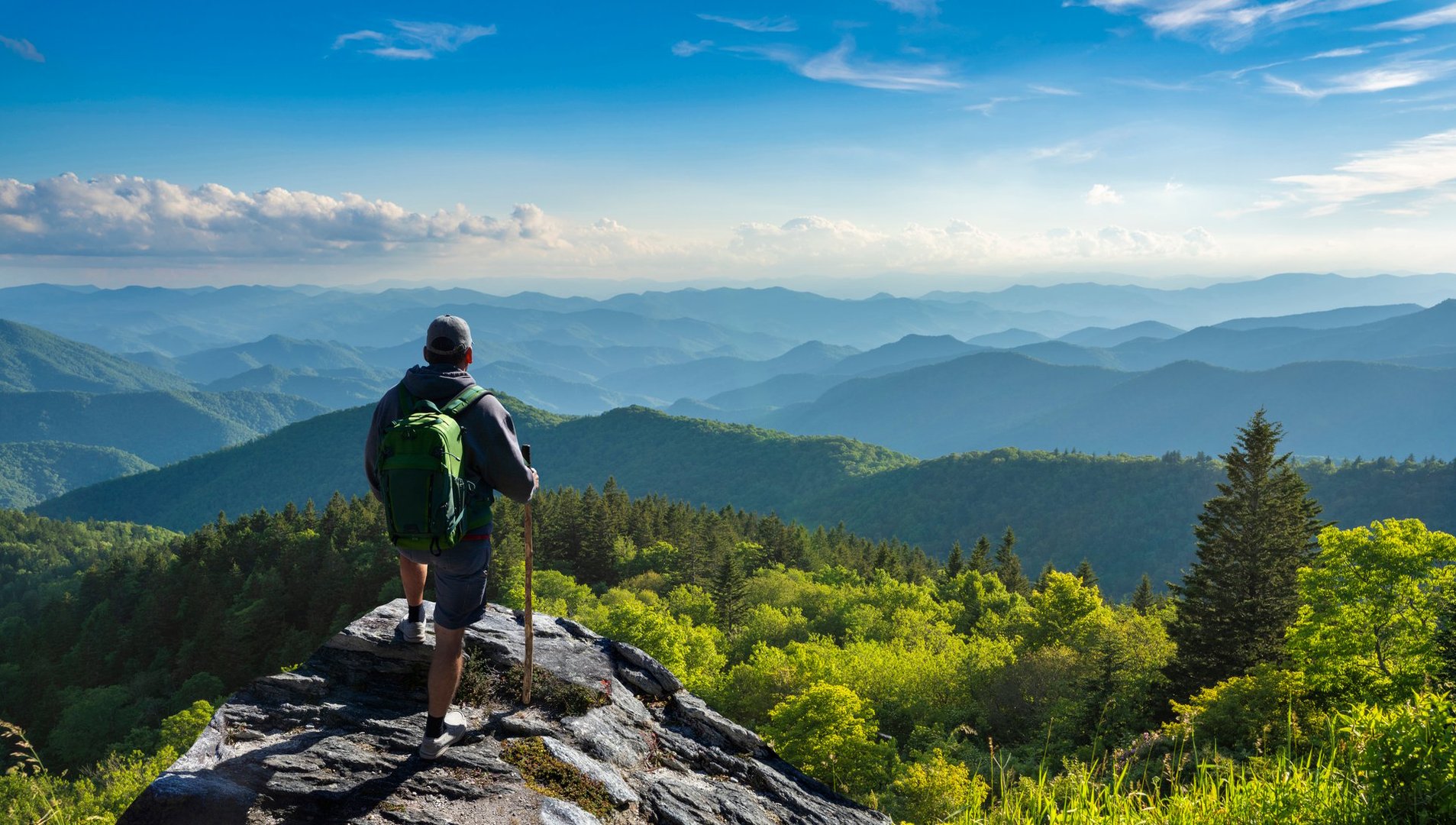 Man hiker  standing  on top of the mountain enjoying beautiful fall scenery.  Near Asheville, North Carolina. Blue Ridge Parkway.USA.