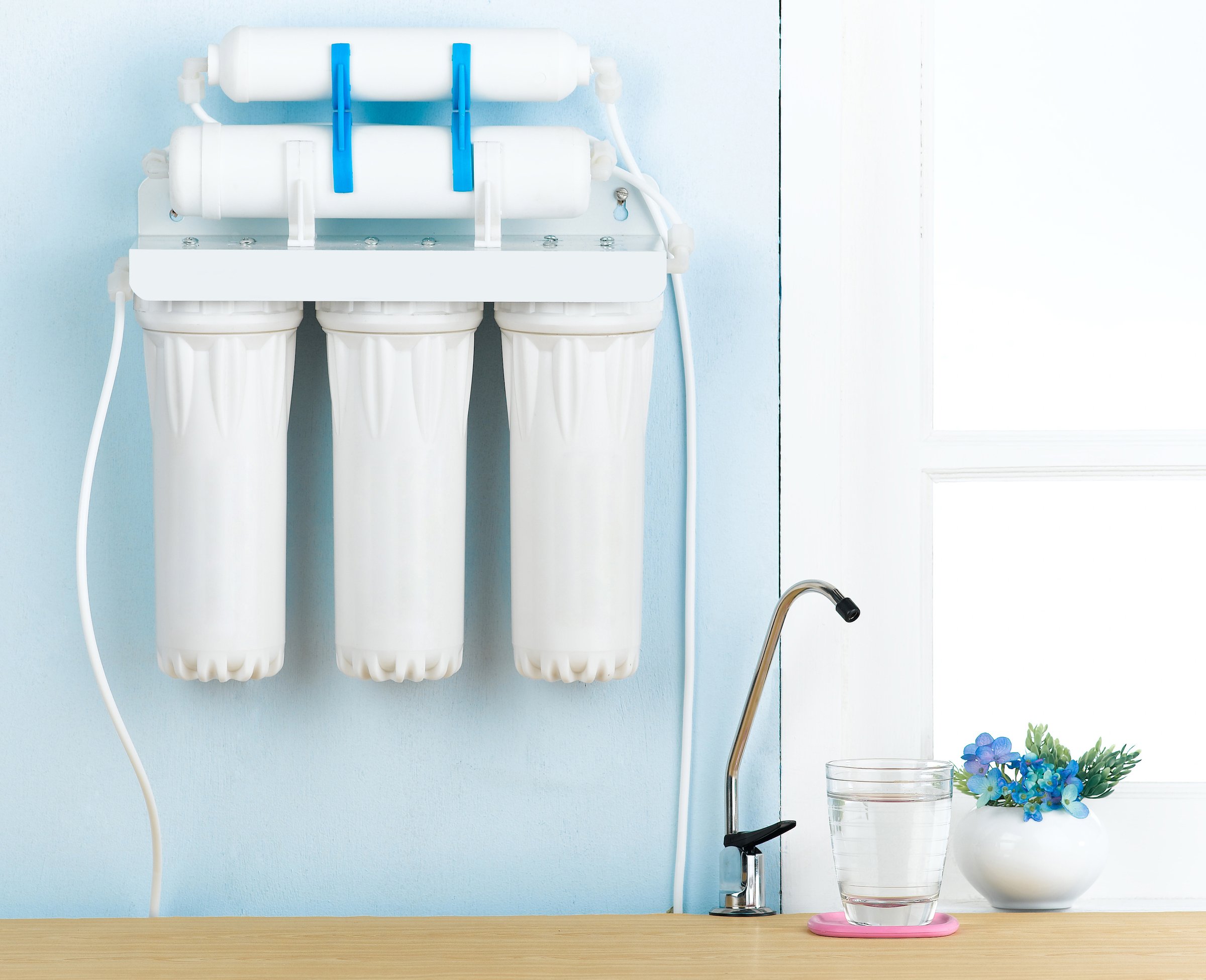 Wall mounted water purifier installation in modern kitchen interior