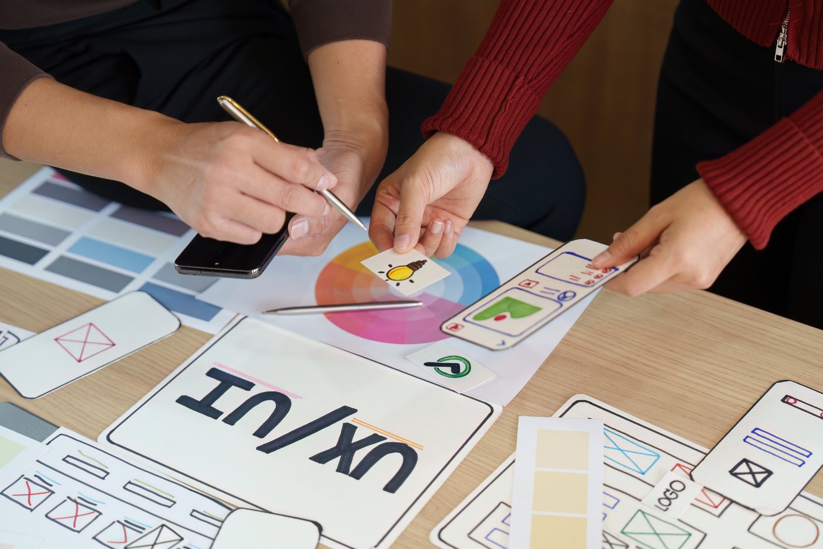 UX/UI professionals delve into color palettes and design elements, fostering collaboration through visual brainstorming to enhance user experience.