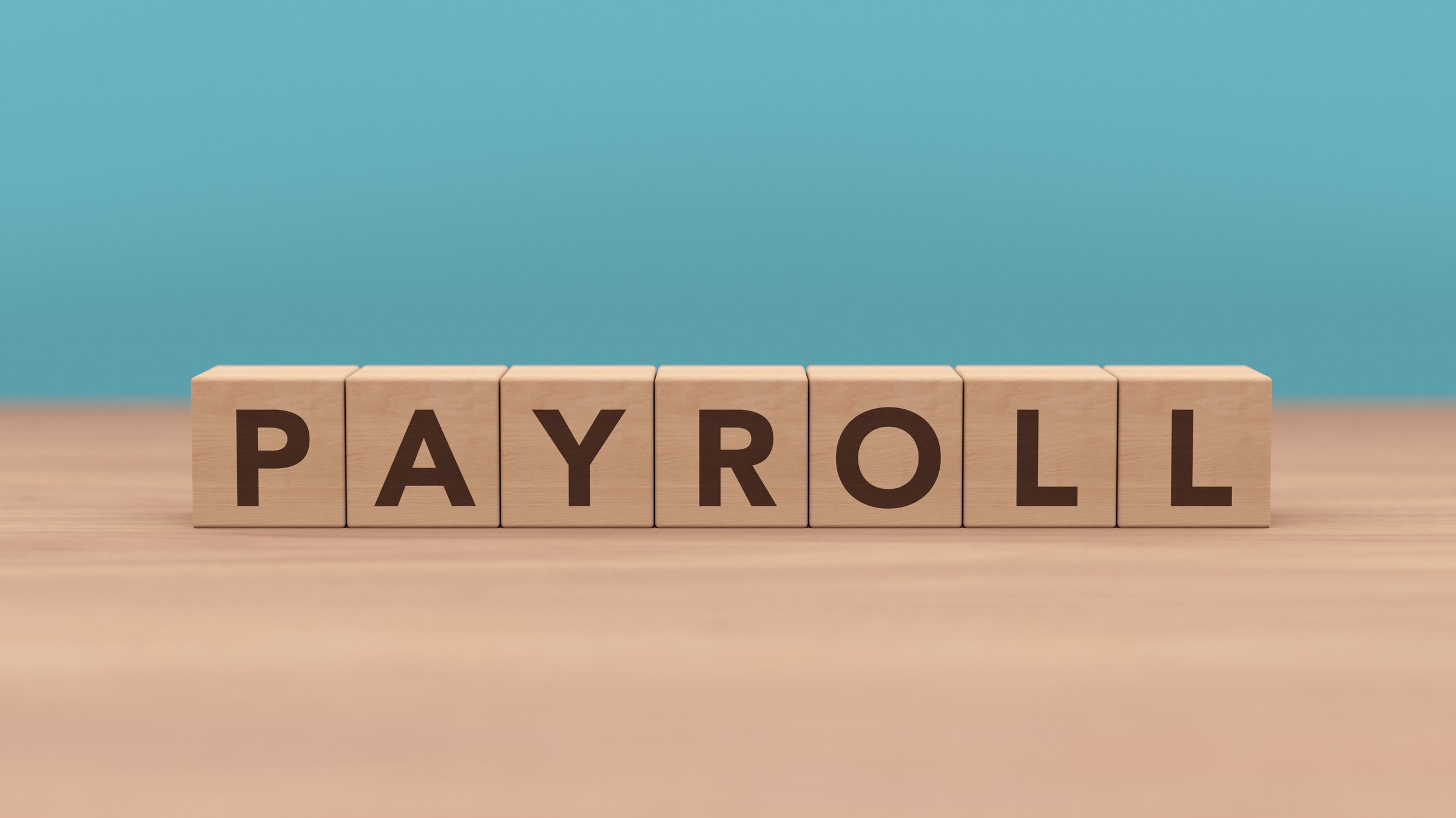 PAYROLL word and letters on a wooden cube blocks