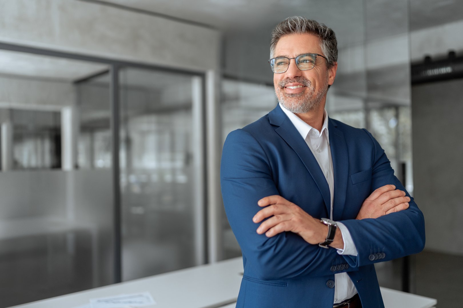 Portrait motivated executive confident senior business man specialist looking dreaming at copy space. Insipired indian or latin hispanic mature middle age boss, leader, ceo male businessman in office