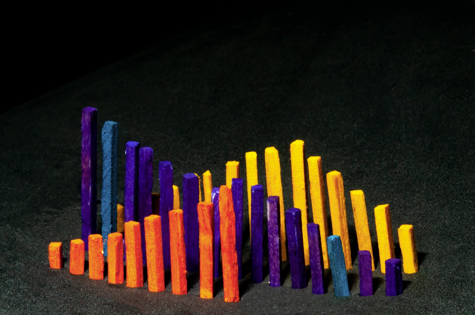 Wooden colorful sticks as a bar graph in 3D view in black background
