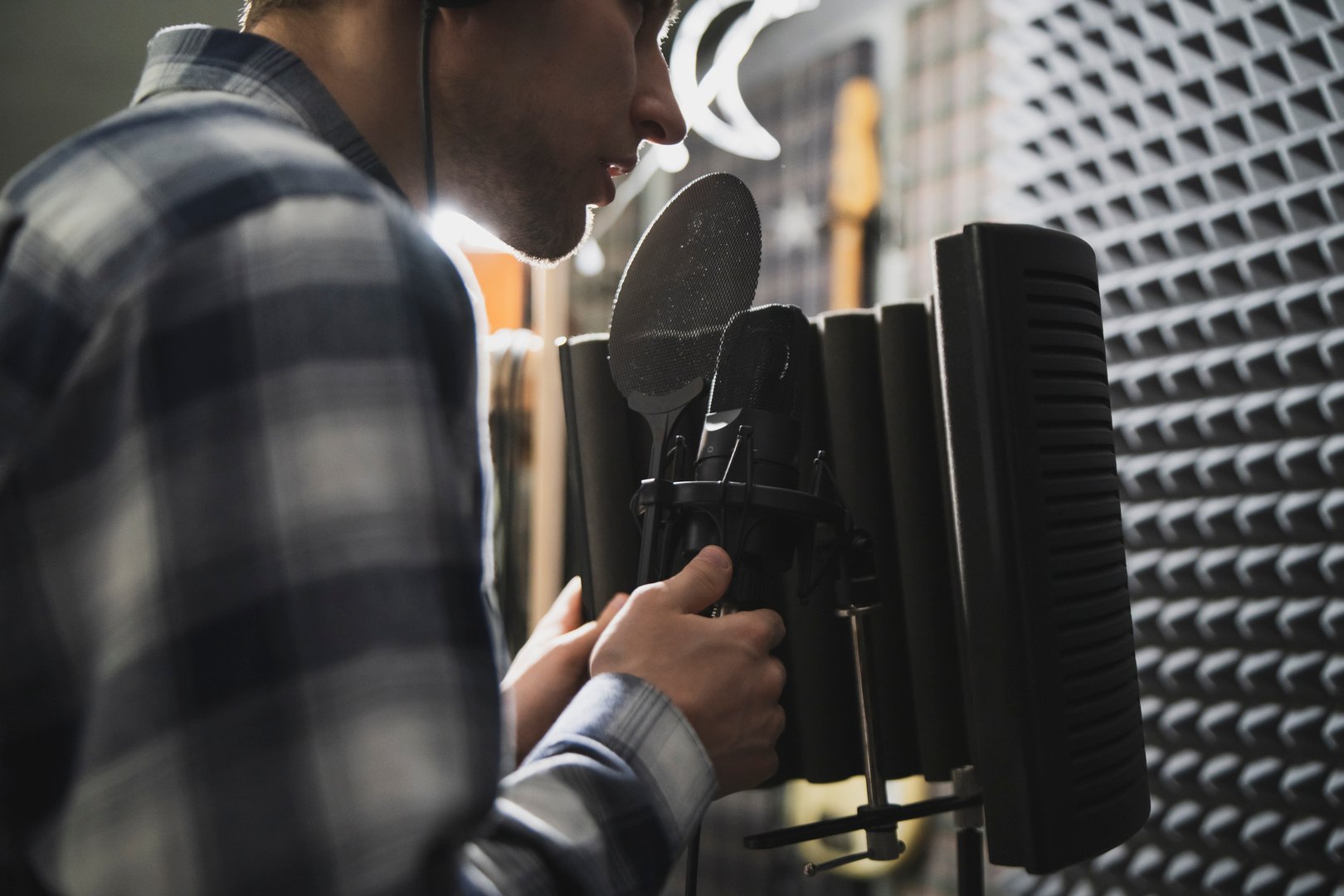 Aspiring Rapper Recording a New Track in a Soundproof Studio at Night