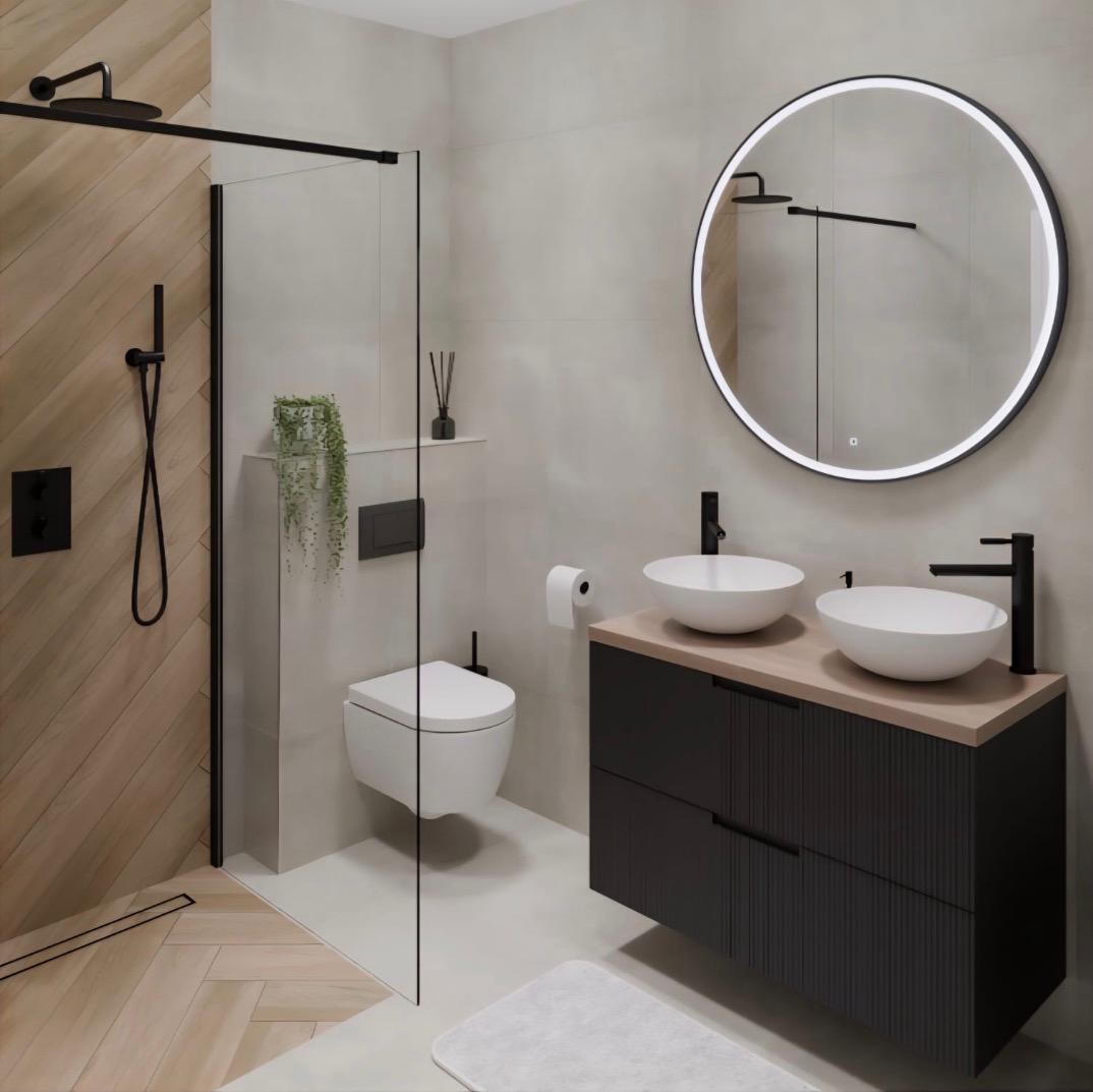A cozy bathroom with a dark wood cabinet, brown quartz countertop, black faucets, and a shower with tan tiled walls and grey herringbone tile floor.