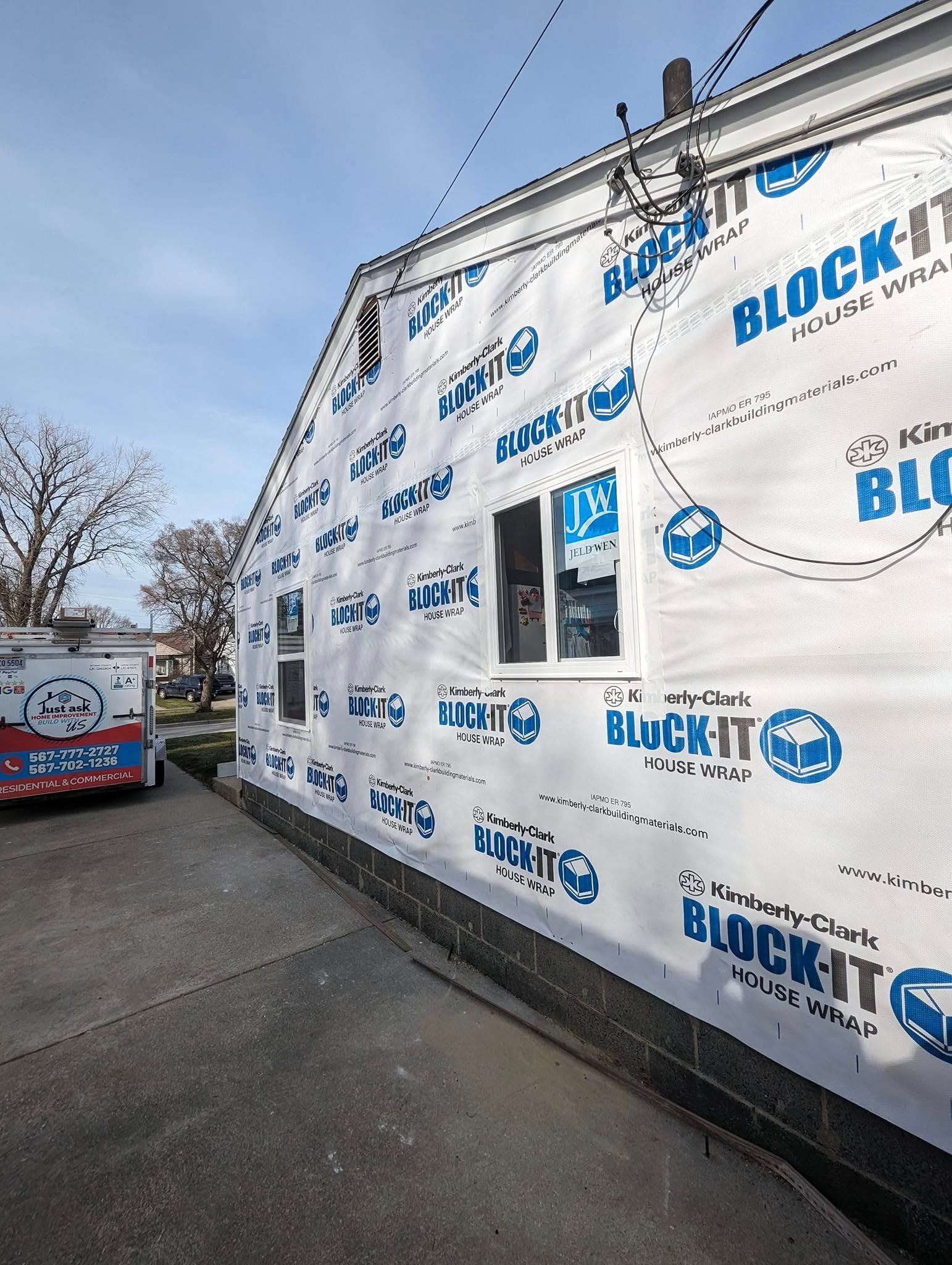 Man installing interior door using spirit level. Professional craftsman in uniform aligning door with tools during home renovation