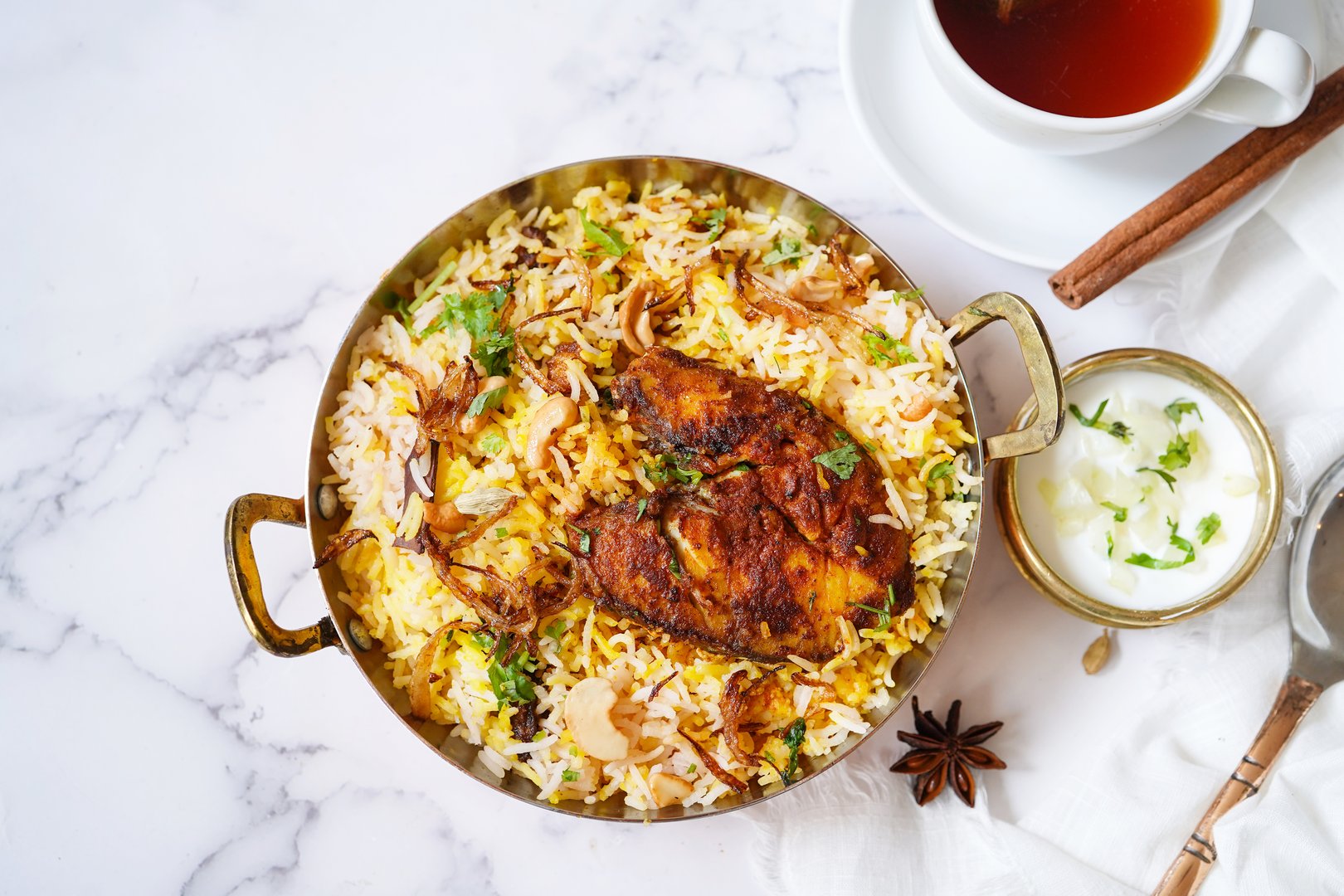 Homemade King fish biryani served with yogurt