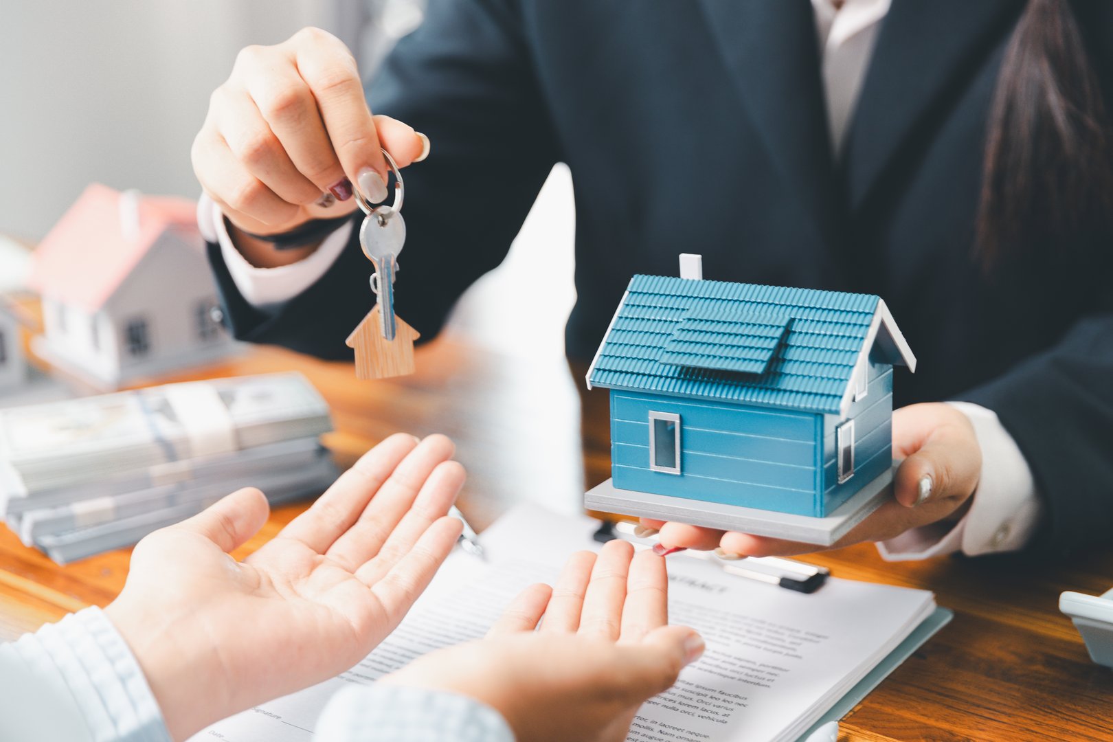 Real estate agent delivering sample home to customer, mortgage loan contract. Contract for hire purchase sale of house. home insurance contract, home mortgage loan concept. real estate, customer