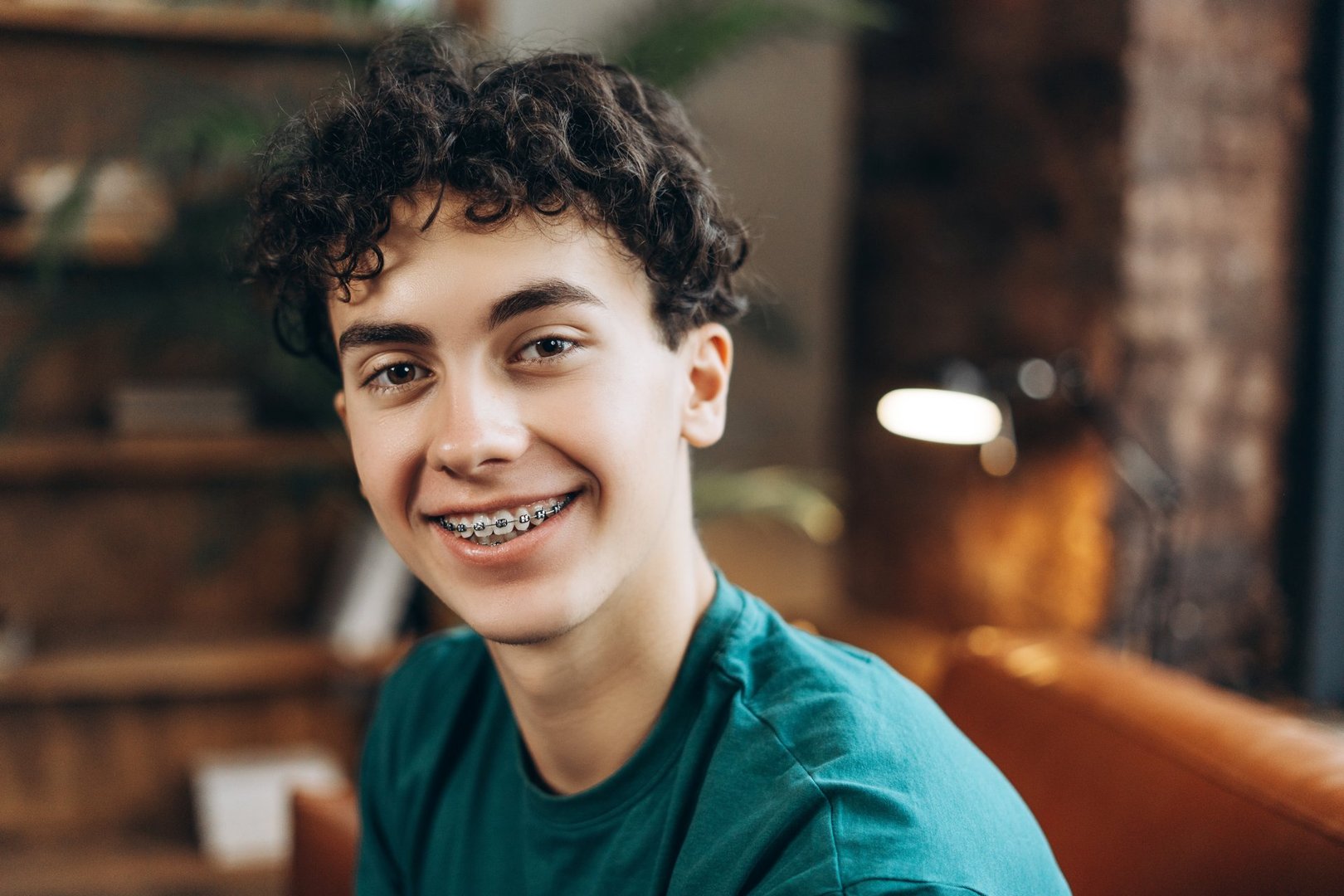 Portrait of friendly teenage boy with braces looking at camera. Psychotherapy services, mental health professional concept