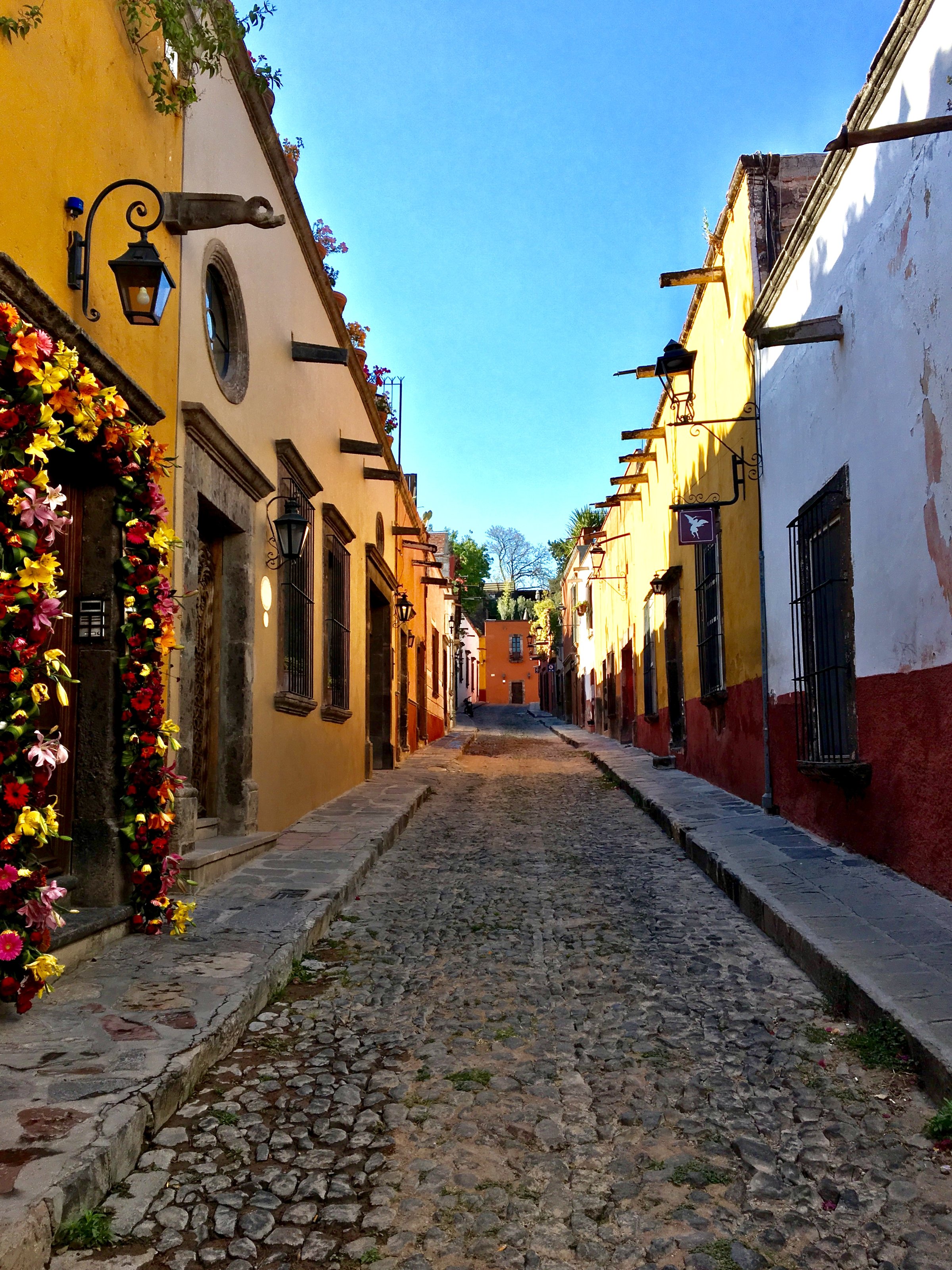 Typical Street scene in Queretero Mexico with flowers decorating doorways