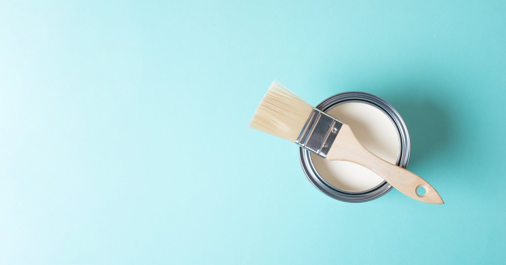 Paint can with white chalk color and a paintbrush, painting old furniture, renovating at home, refurbish, sustainable lifestyle