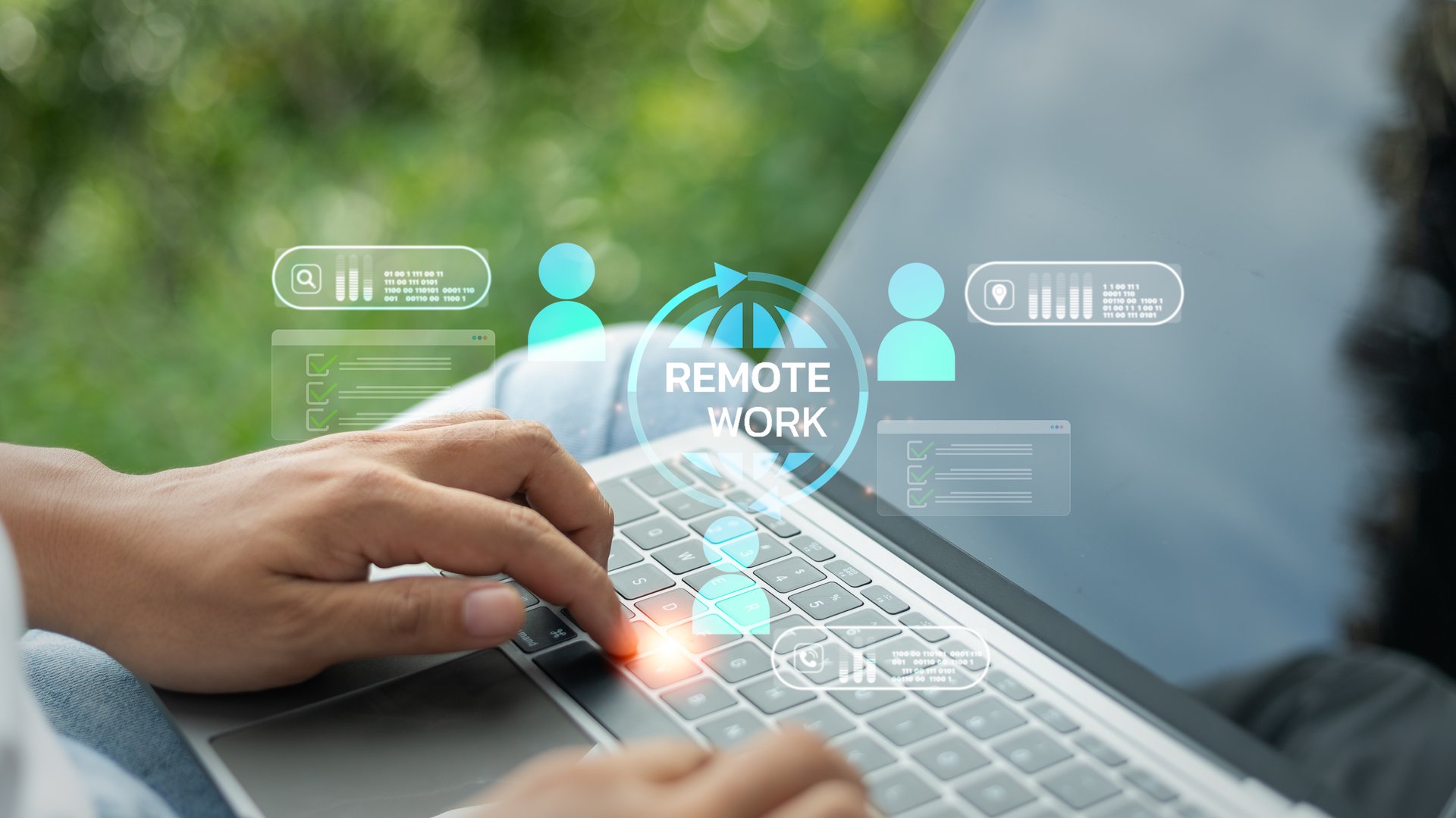 Close-up of hands typing on a laptop with remote work and virtual team icons, representing flexible work, online collaboration, and digital communication in modern business.