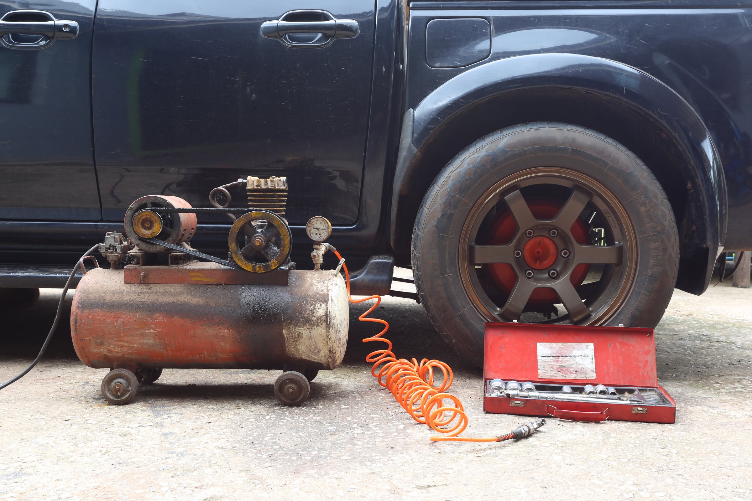 Air compressor pressure pump tool for filling air in motorcycle and car tires at garage,service and repair