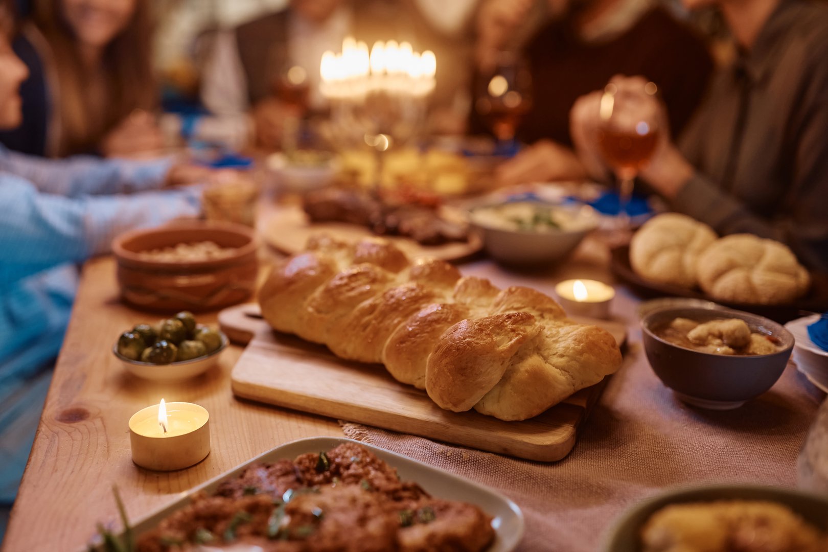 Traditional Challah bread during family dinner on Hanukkah.