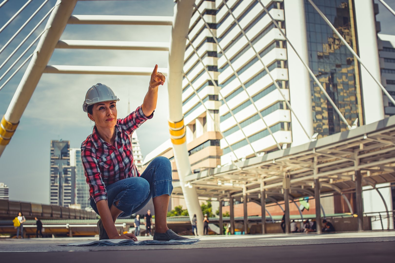 Industrial construction engineer wear safety helmet engineering working and drawings inspection on building outside. Engineering tools and construction concept. Business industry concept. copy space.