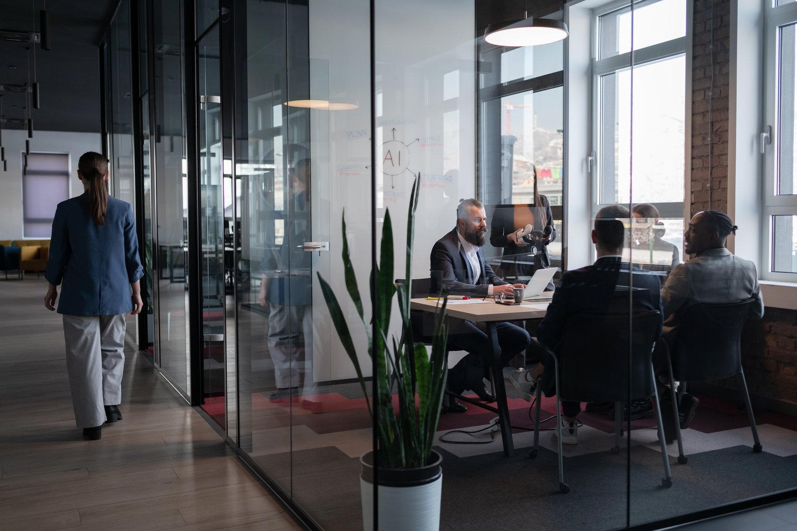 Modern office meeting in a glass-walled conference room