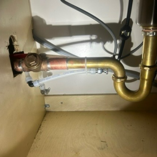 Professional plumber working on plumbing installation