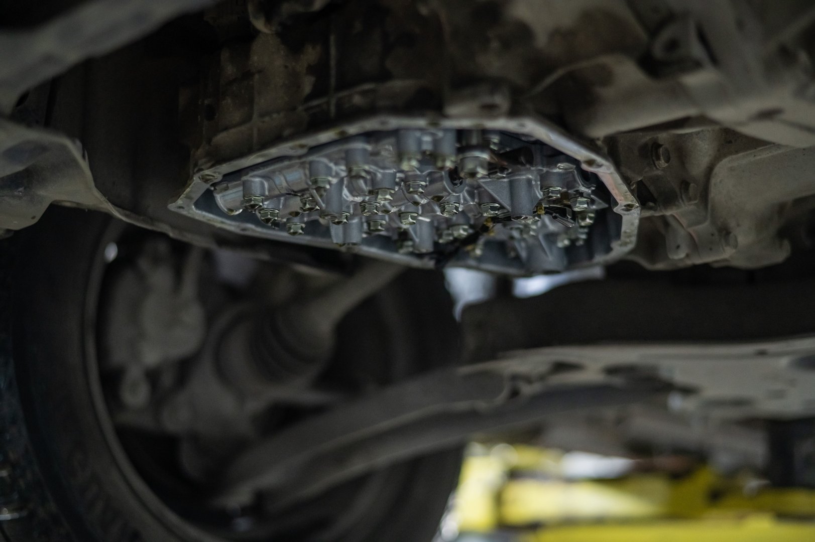 Close-up of a car's CVT gearbox on a lift