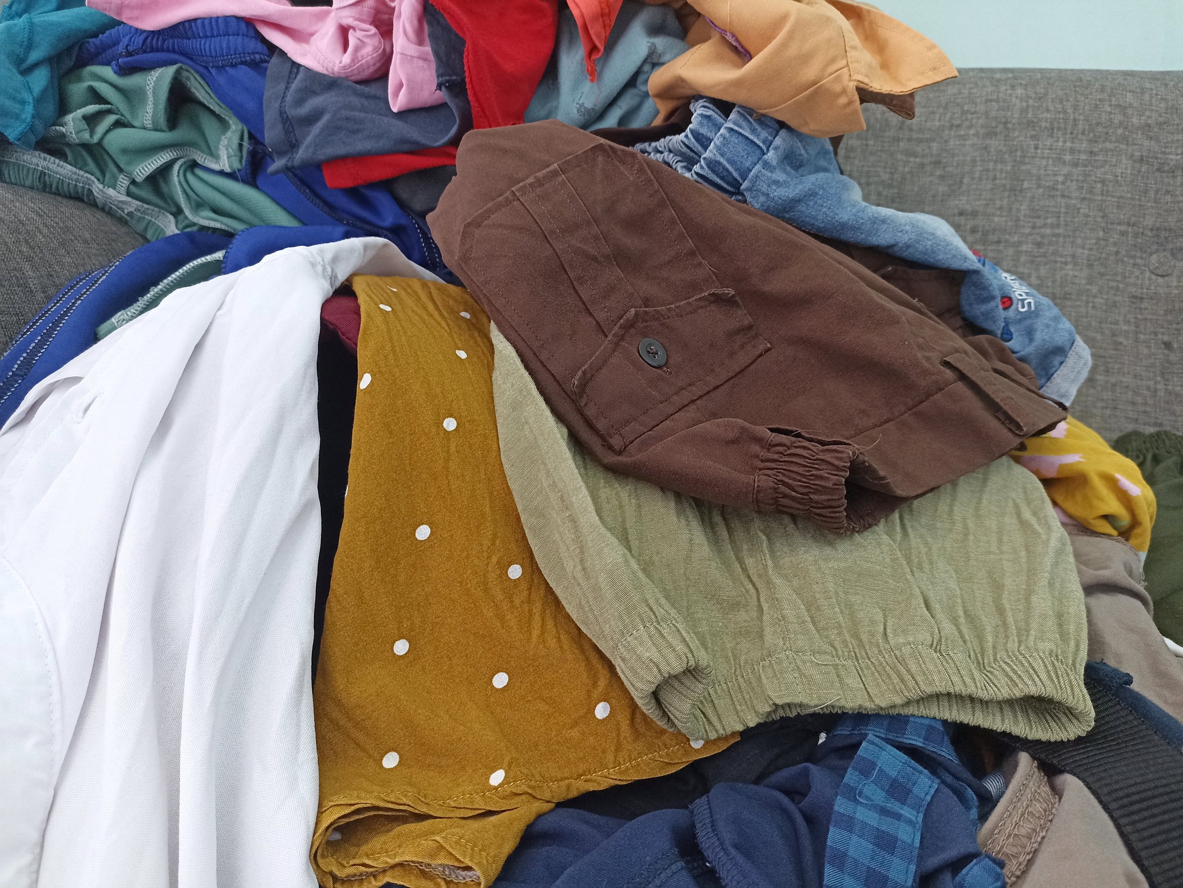 piles of various kinds of colorful clothes finished being washed