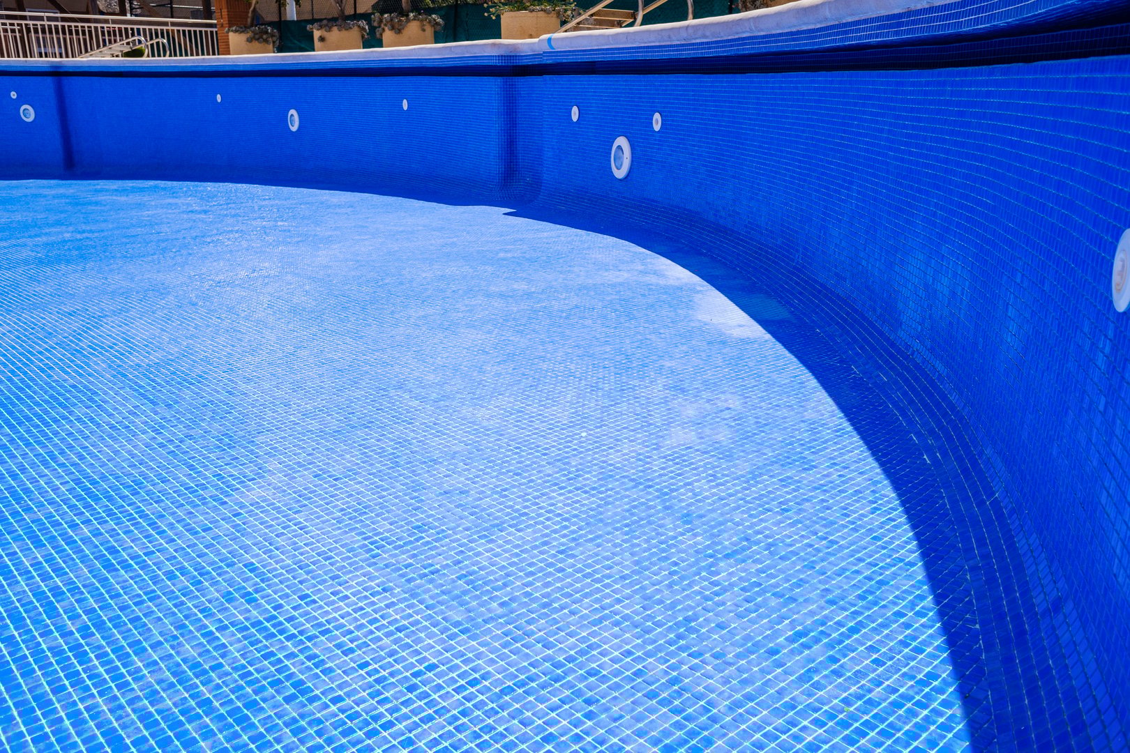 Cleaning an empty swimming pool in a residential