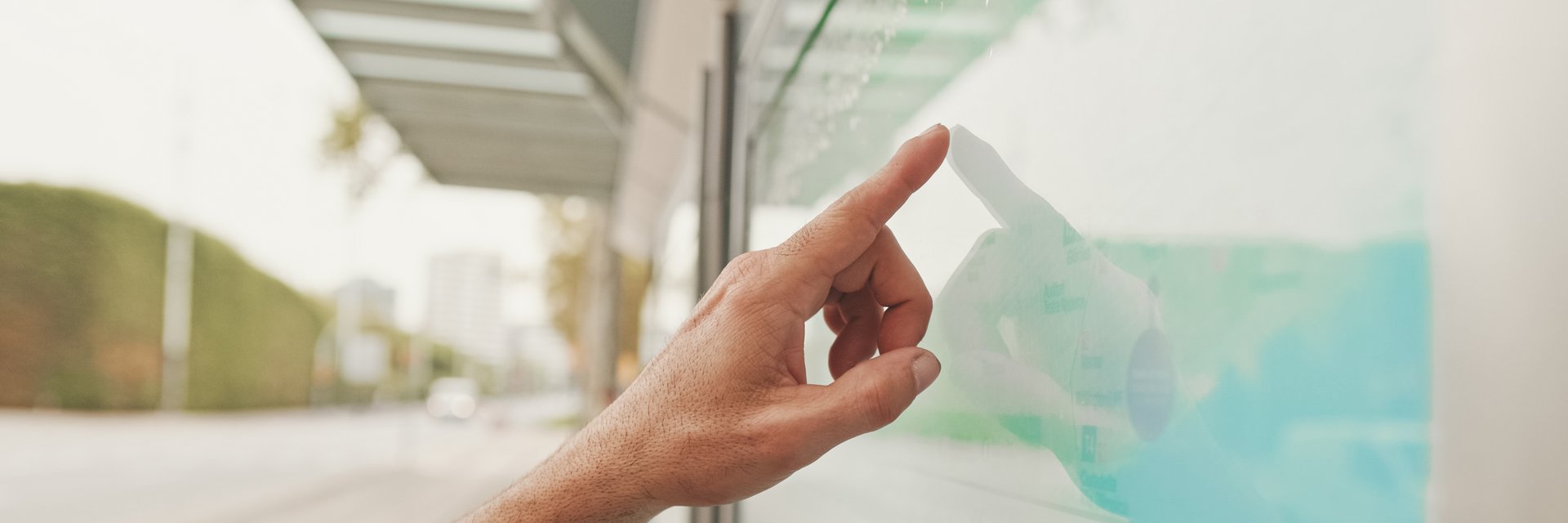 Close-up of unrecognizable man's hand pointing with finger searching public transport traffic