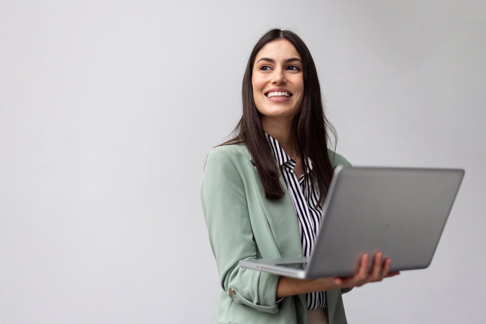 Smart Latina entrepreneur checking updates on a laptop she is holding