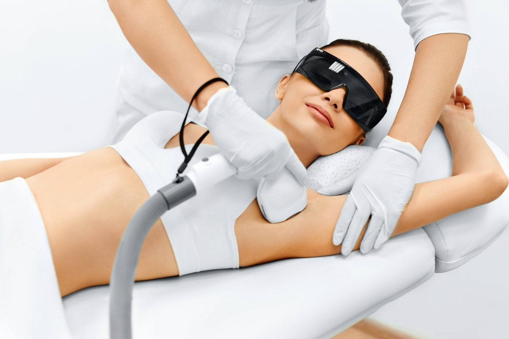 Body Care. Underarm Laser Hair Removal. Beautician Removing Hair Of Young Woman's Armpit. Laser Epilation Treatment In Cosmetic Beauty Clinic. Hairless Smooth And Soft Skin. Health And Beauty Concept.