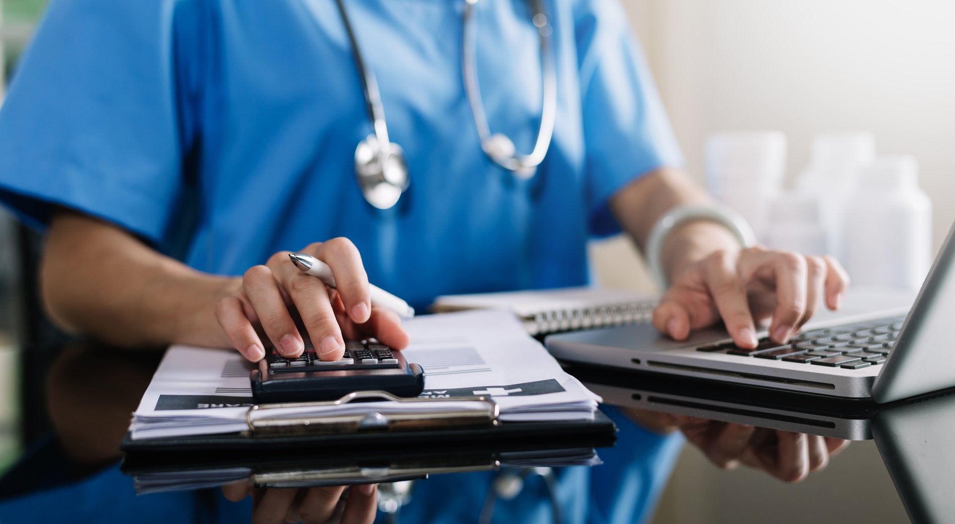 Doctor calculating medical costs and finance