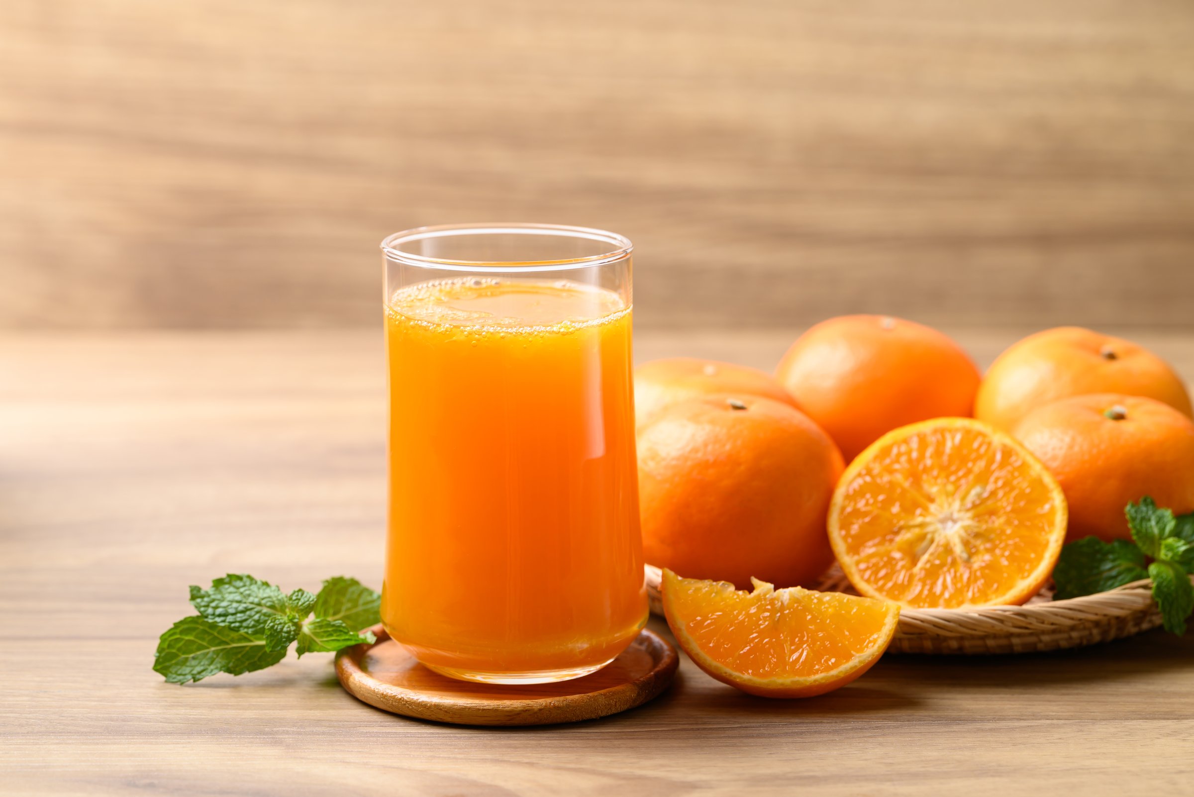 Glass of orange juice and fresh orange fruit on wooden background, Healthy drink