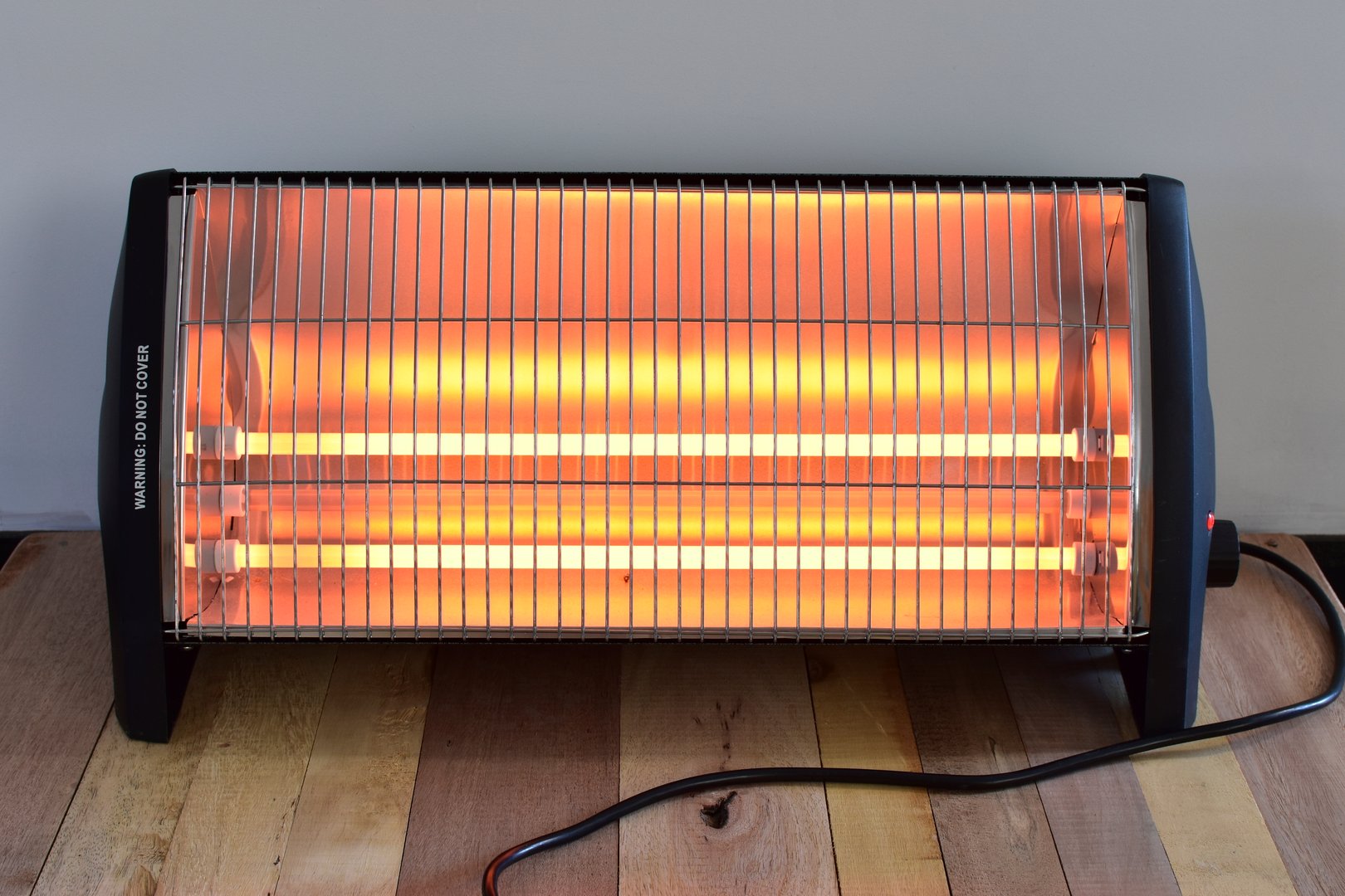 A electric bar heater, close up. switched on and radiating heat.