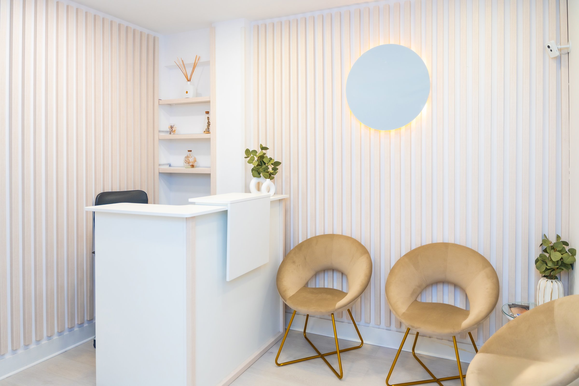 Minimalist and chic interior of a reception of beautician clinic with counter and chairs