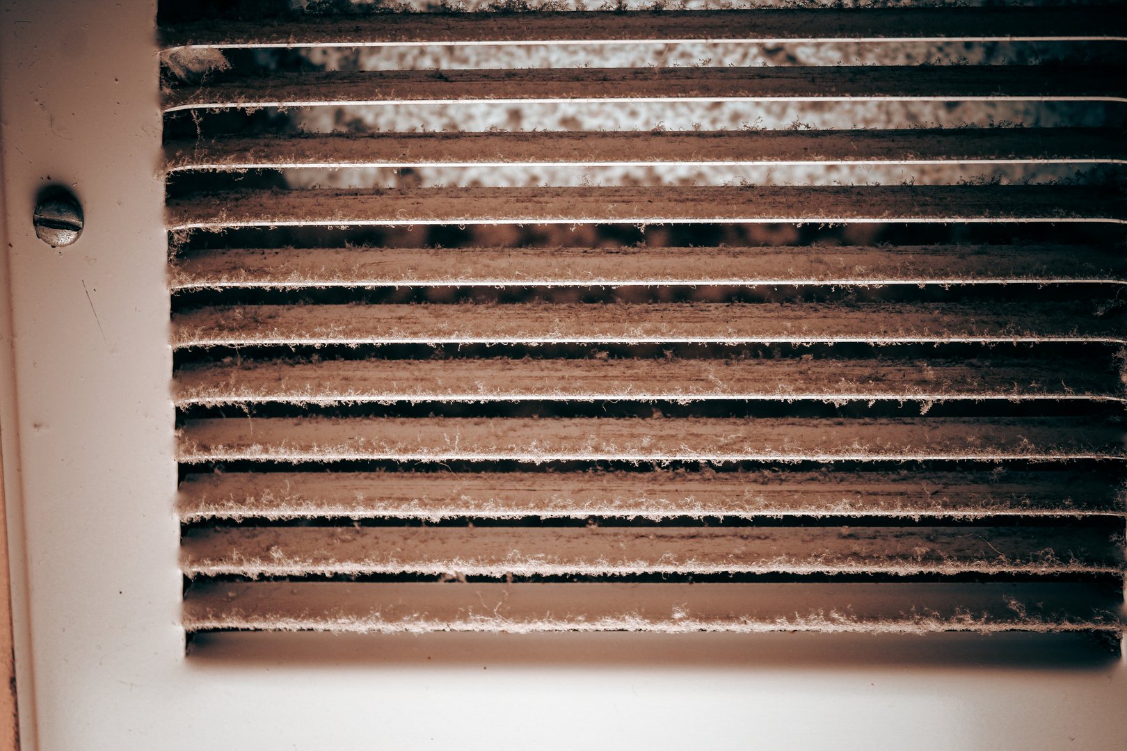 close-up of dusty air register ventilation system dirty needs cleaning abstract backdrop