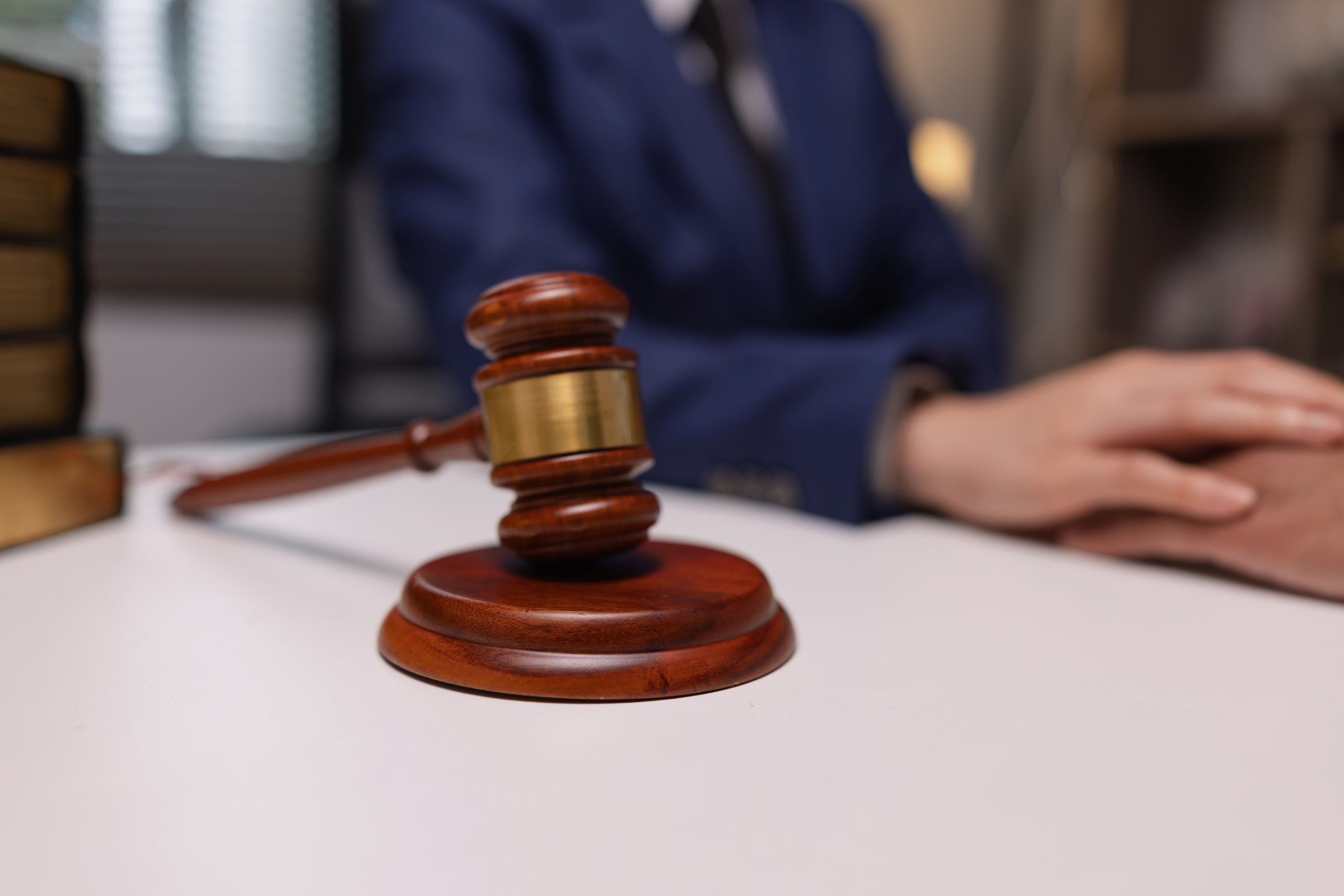 lawyer holding hands of client in a comforting gesture in law firm office, law firm agreement concept.