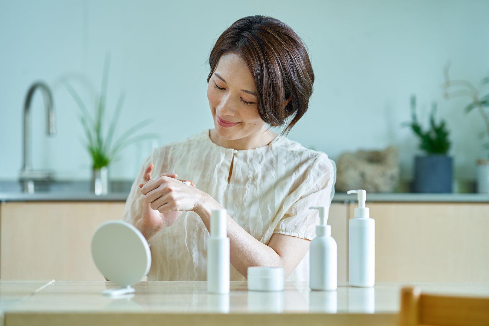 Middle-aged woman applying cream to the back of her hand