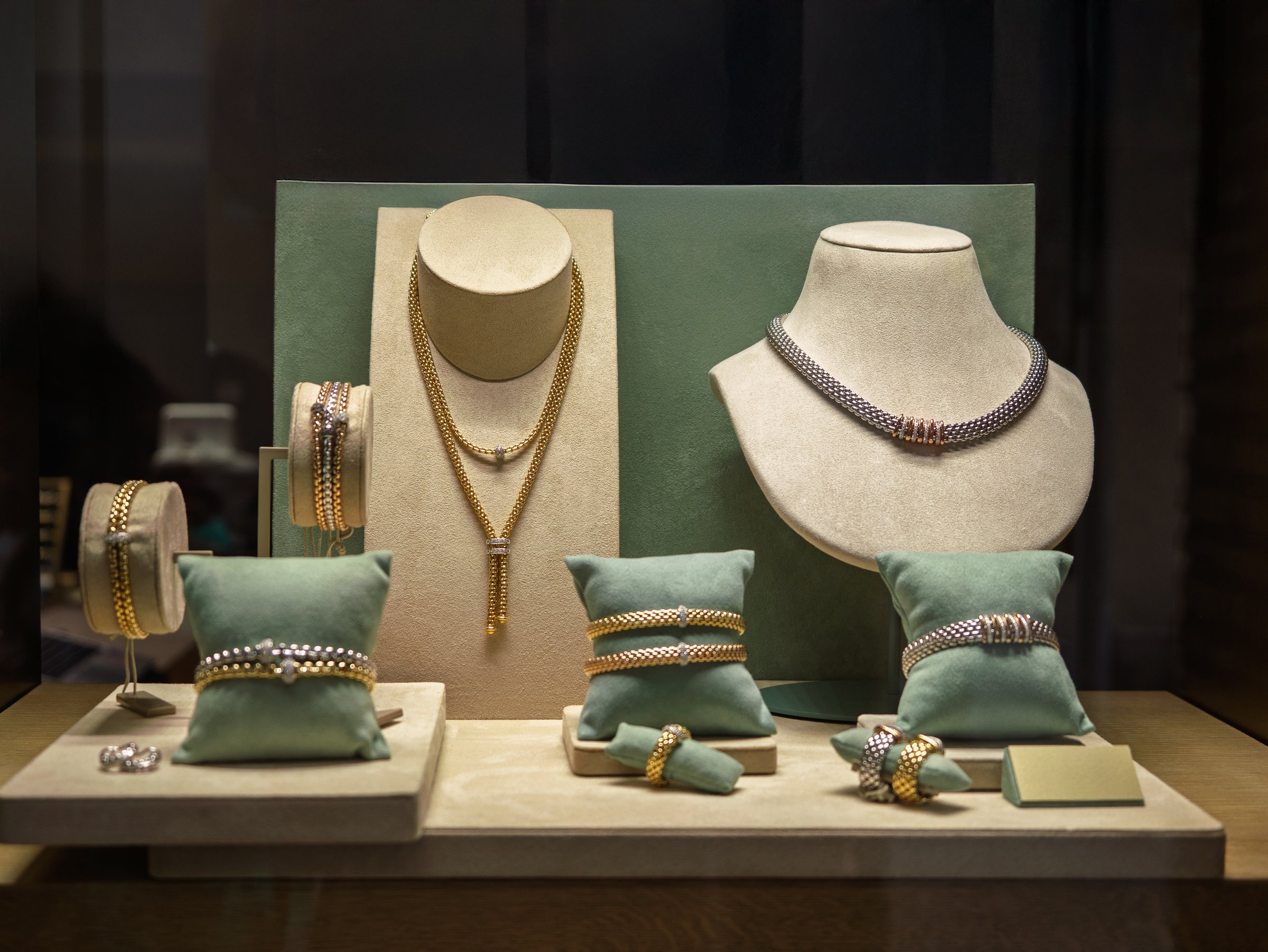 Assortment Of Necklaces Earrings And Bracelets Displayed In Shop Window.