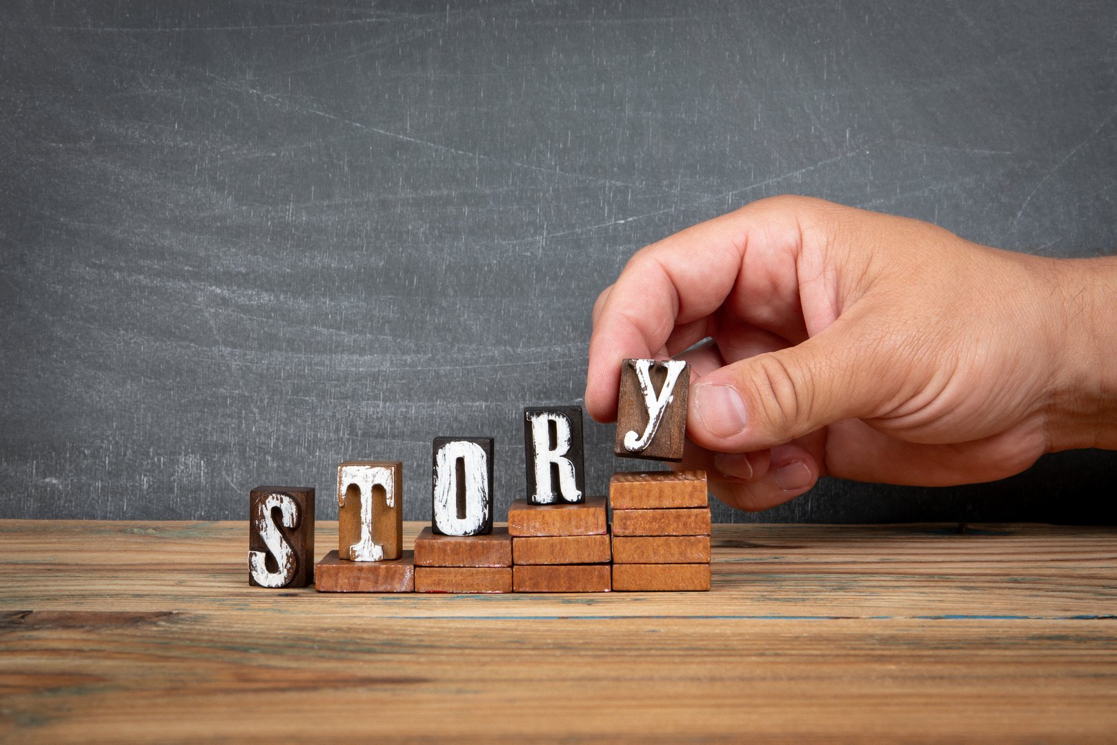 STORY. Wooden letters, alphabet blocks on steps. development and growth concept.